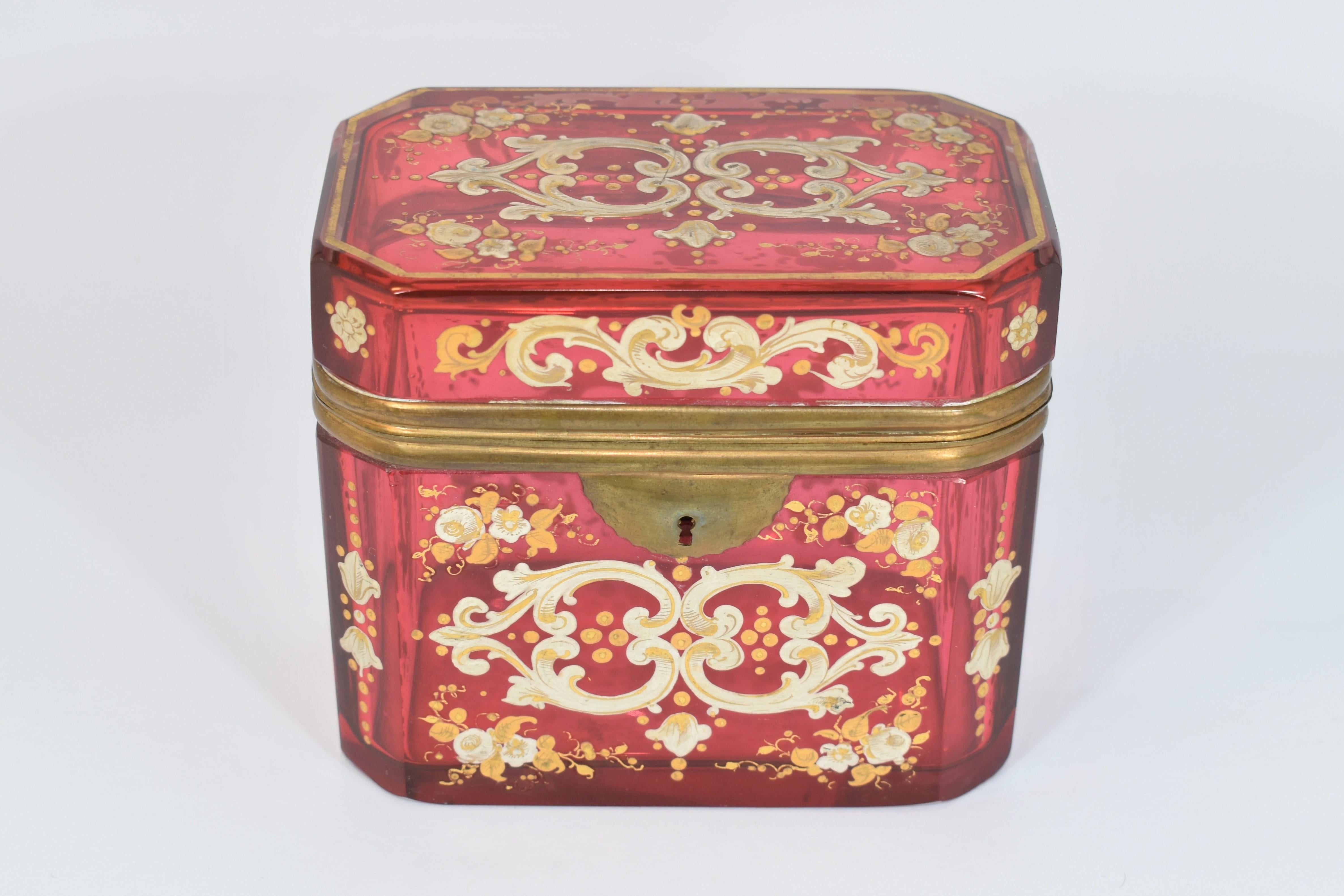 Antique Bohemian jewellery box, 2nd half of the 19th century, cranberry glass, with floral-ornamental gilded enamel decoration all around

High quality Bohemian crystal.
