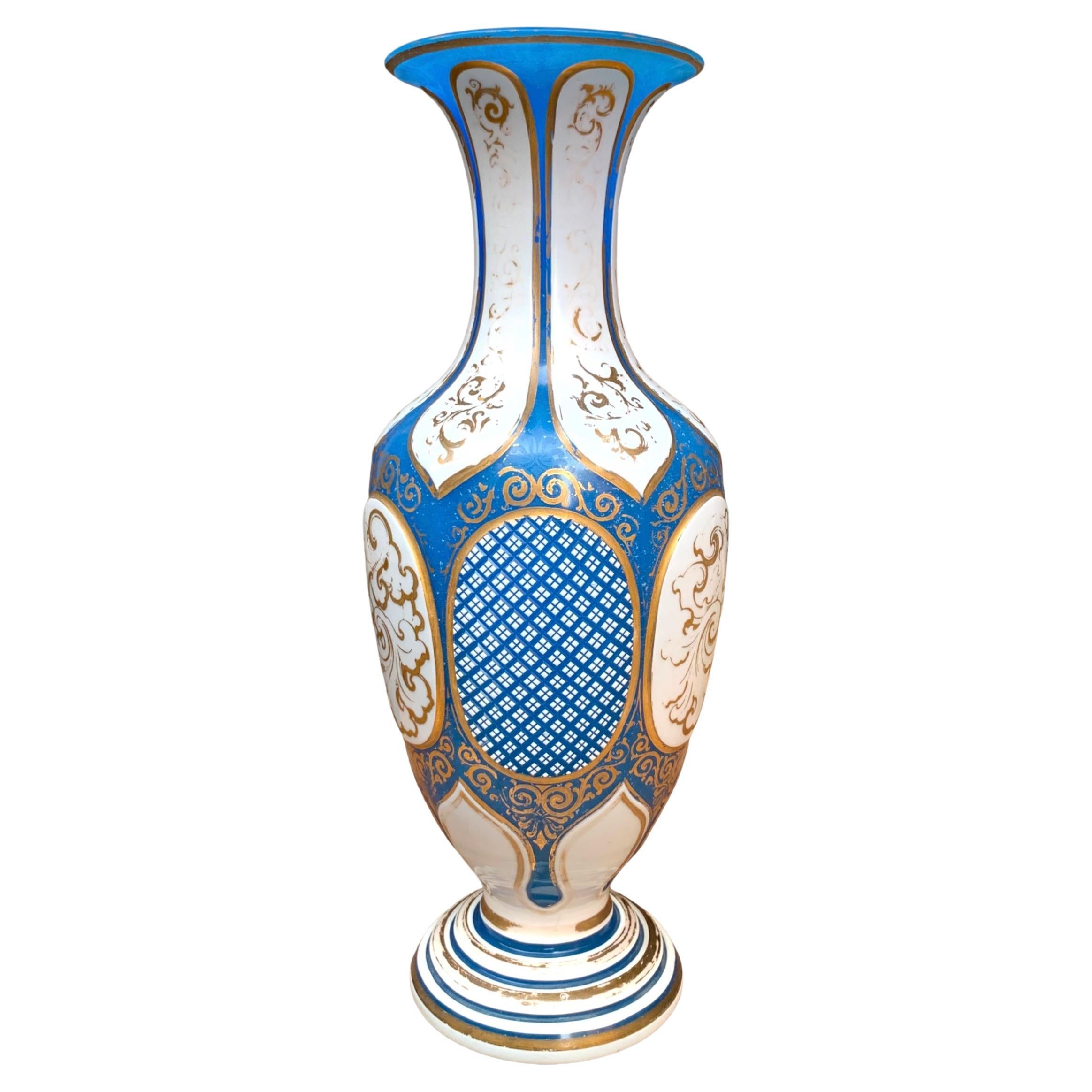 Opaline Alabaster glass vase with milky white opal glass overlay
Various Cut decorations to the glass all around the body
Gilded Enamel decorations on both the Blue and the White Layers
Bohemia, 19th Century.