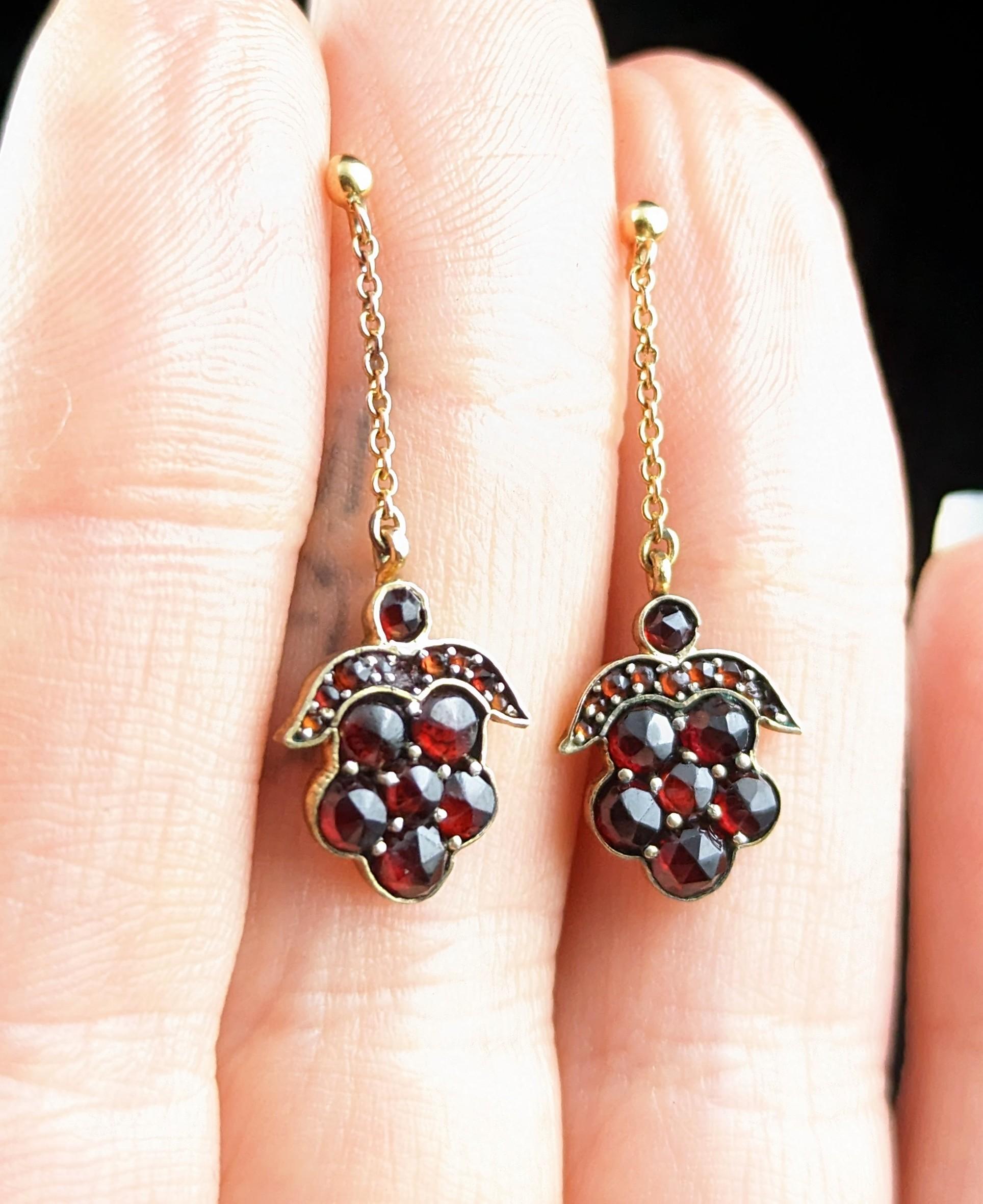 Antique Victorian Bohemian Garnet drop earrings in 8kt yellow gold.

These are such a pretty and delicate pair of earrings, the main drop made up from round cut Bohemian Garnets displayed in a floral design which also resembles a bunch of