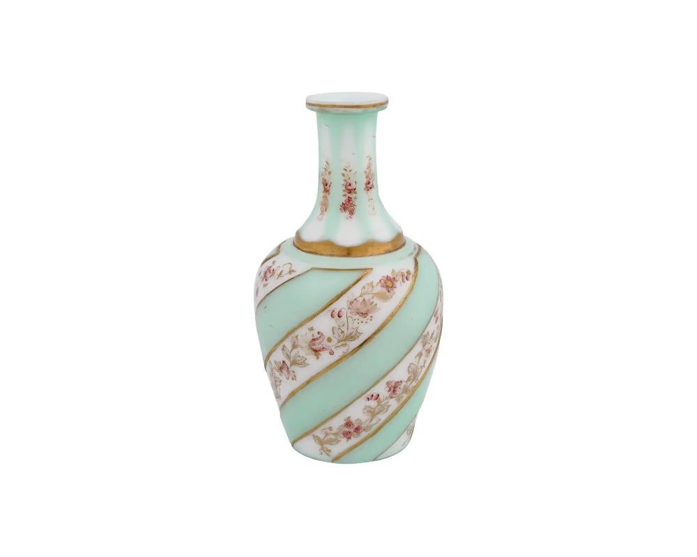 A vintage European, probably Czech, Bohemian glass cut overlay decanter. The ware is made in a panel design. The exterior of the decanter is adorned with hand painted floral and foliage motifs, and gilded accents. Gilded rims. Unmarked. Circa: late