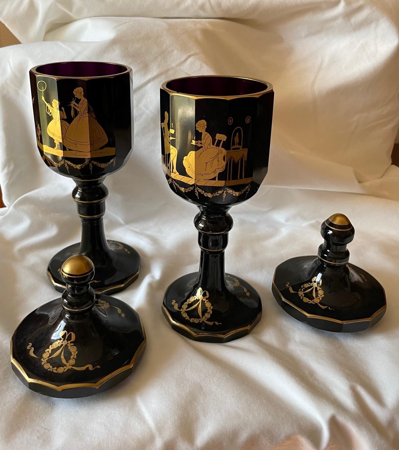 Antique Bohemian Moser large pair of Lidded Amethyst crystal Goblets 19th century

Outstanding pair of heavy Moser rich dark amethyst crystal goblets with lids. Artfully hand gilded scenes embellish the beautiful shape of the goblets. The dark