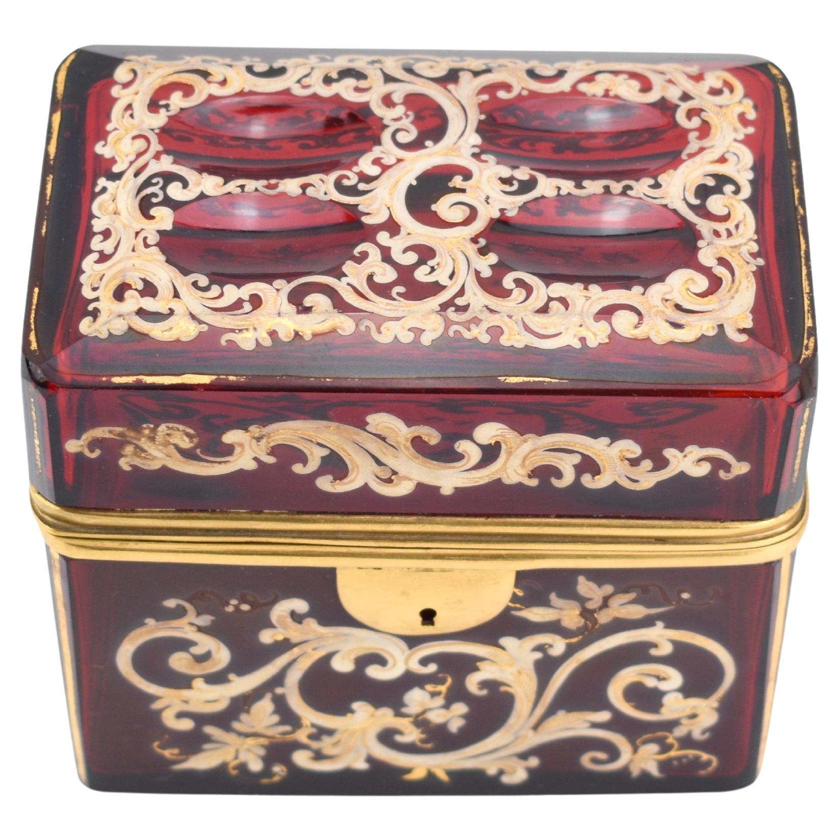 Antique Bohemian Ruby Red Crystal Glass Jewelry Casket – 19th Century
This exquisite 19th-century Bohemian jewelry casket is a rare and luxurious example of fine crystal craftsmanship. Made from deep ruby red transparent crystal glass, the box is