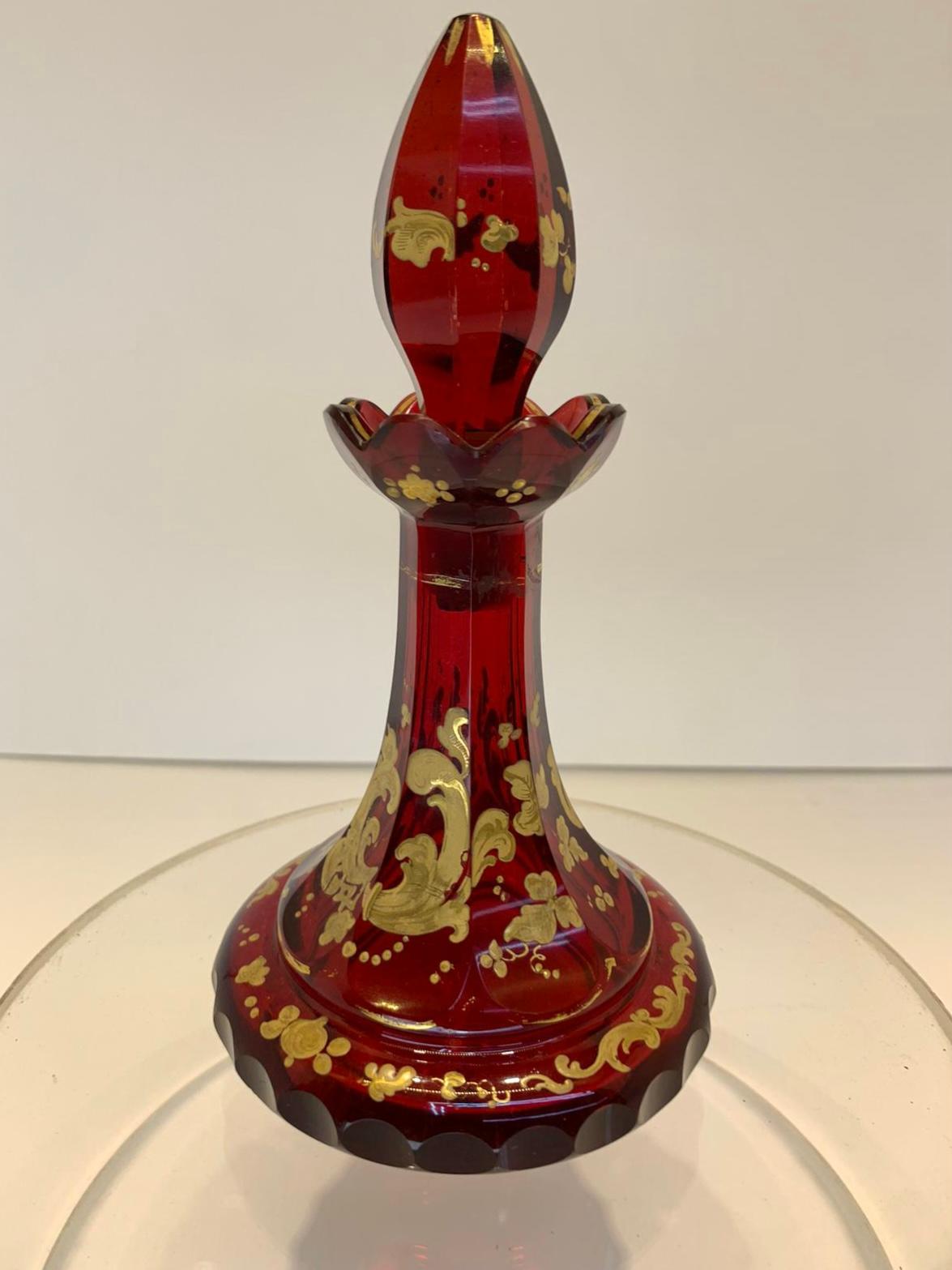 Bohemian crystal, deep ruby cut glass perfume bottle and stopper.
decorated with impressive gilded enamelled decoration.
Bohemia, 19th century.