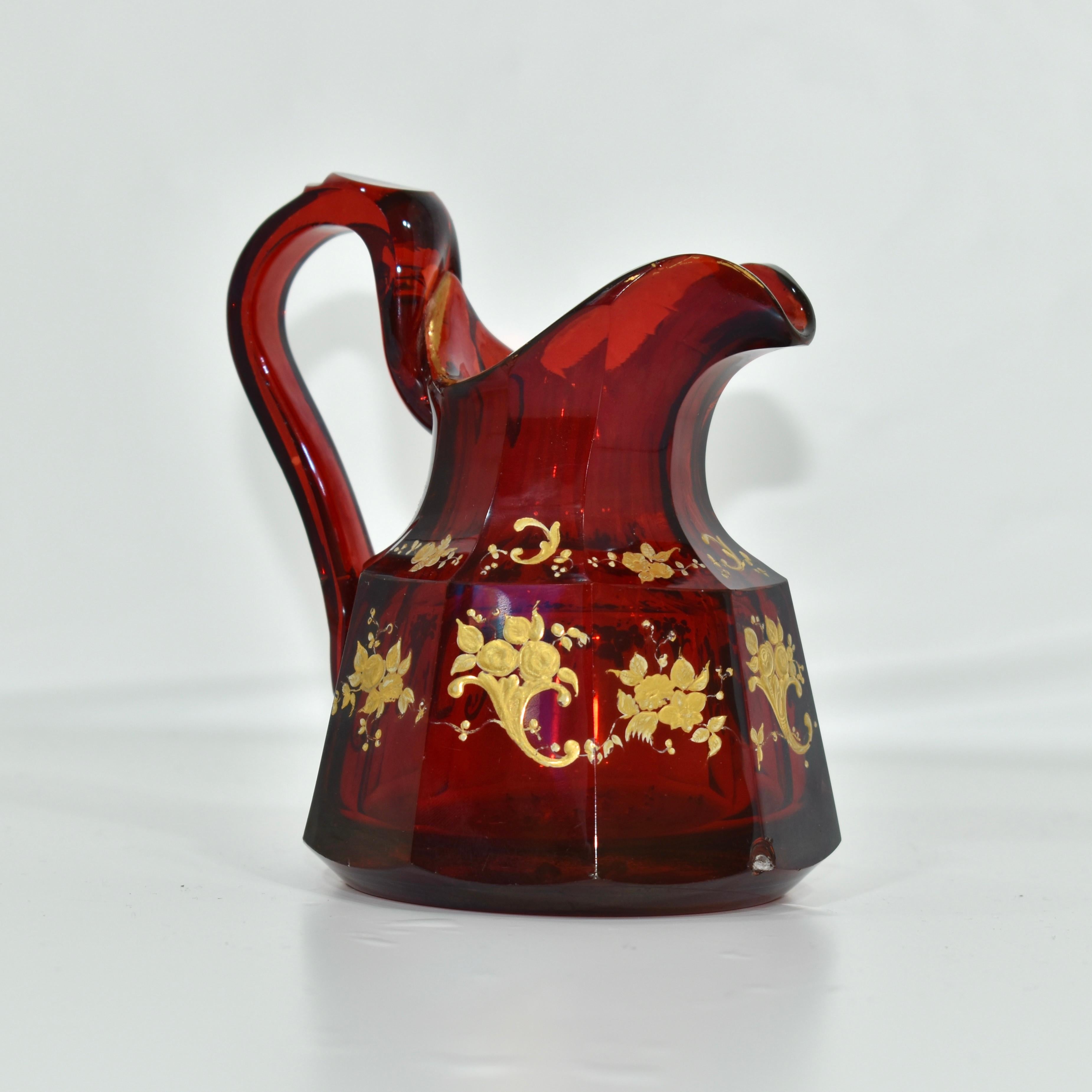 Antique glass jug in ruby red crystal glass
impressive quality, color and substance
Hand-painted with gilded enamel decoration featuring scrolls and flowers, in addition to gilding highlights.