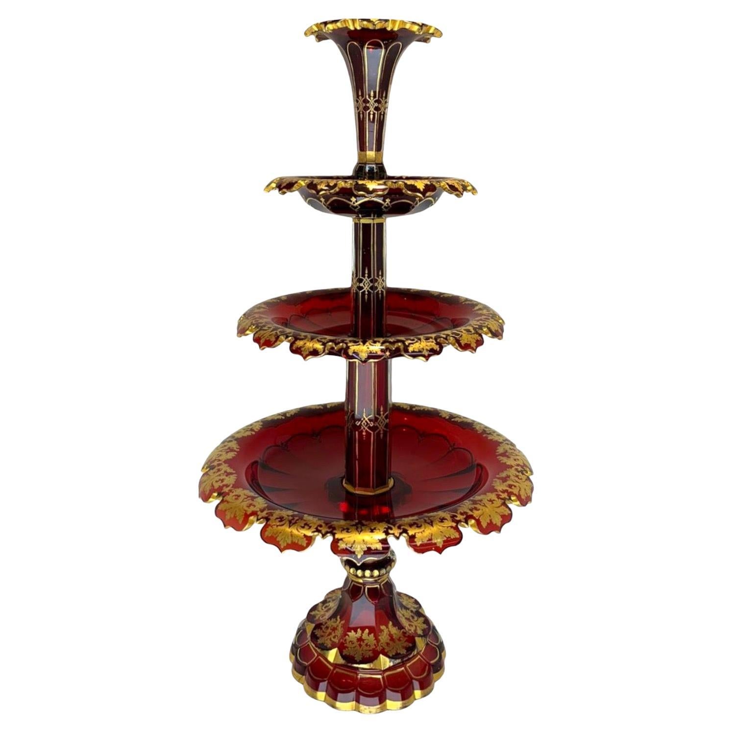 Museum Quality Bohemian Ruby Red Crystal Centrepiece with Fine Gold Enamelling.

Comprises of a Stand, 3 Dishes and a Top Vase.

The Gold Decoration is in Excellent Condition.

A Wonderful Example of The Highest Quality Bohemian Glass.