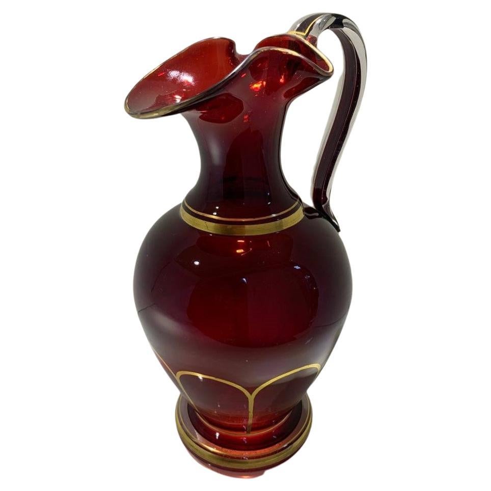 Art glass pitcher, ruby red glass
impressive size, color and substance
fine example of the bohemian glass manufacture of the 19th Century
circular body, the rim is beautifully shaped in a wavy form with gilded edge
Further gilding on the body and
