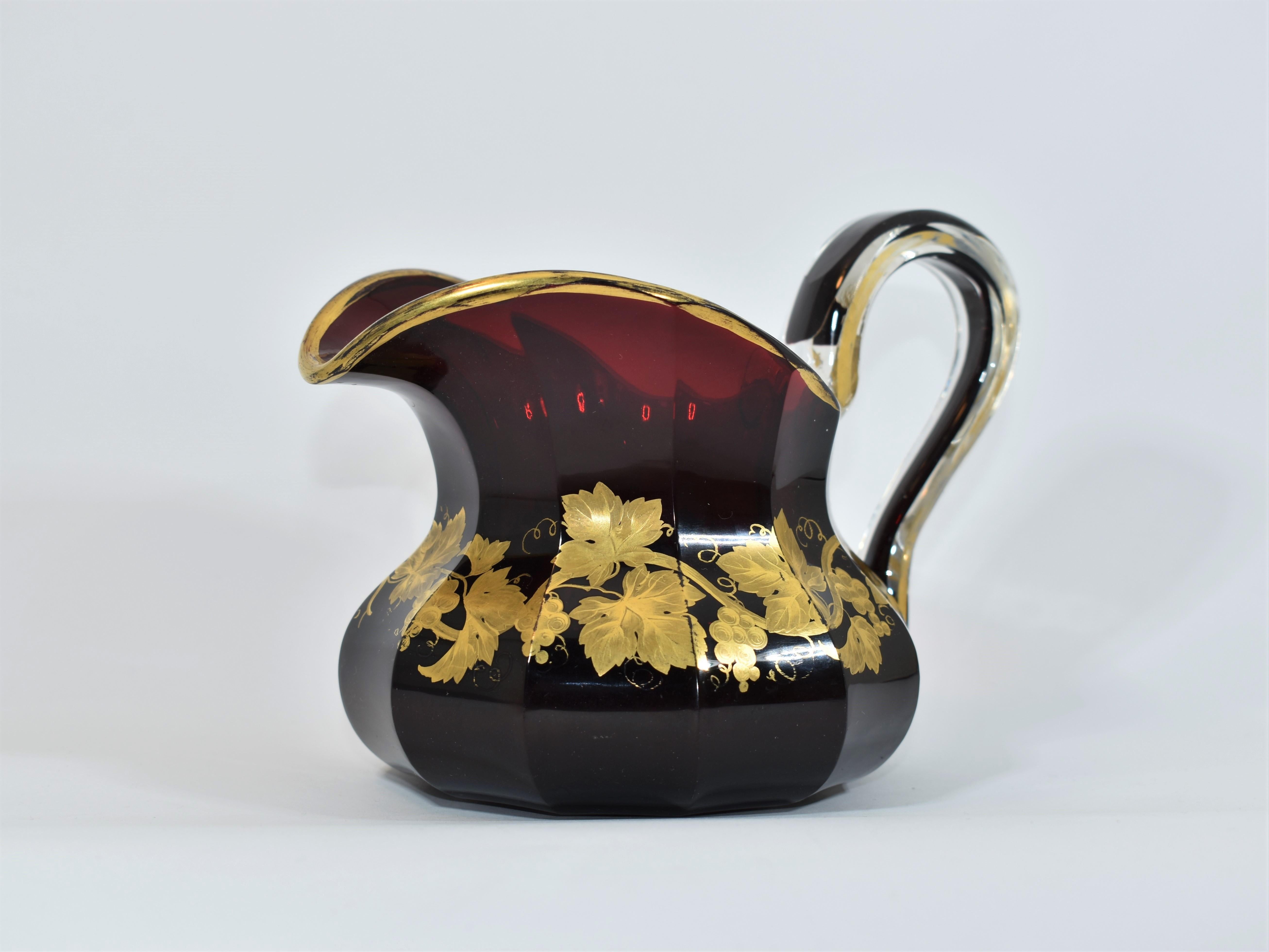 Antique glass jug in ruby red crystal glass
impressive quality, color and substance
Hand-painted with gold enamel featuring vines and gilding highlights.