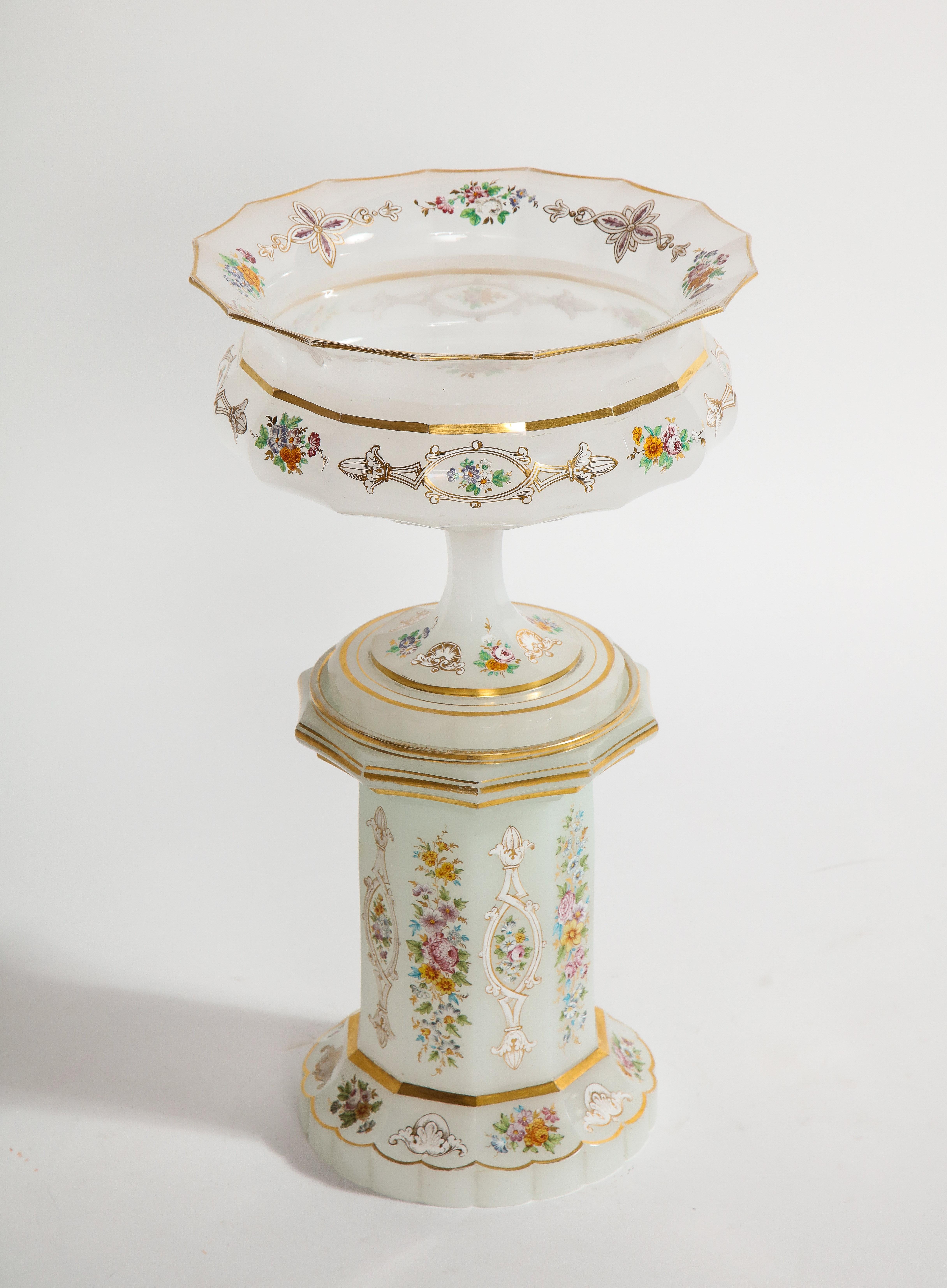 A rare hand-carved and faceted 19th century antique bohemian white opaline centerpiece resting on its original white opaline plinth. The opaline crystal is of the finest quality with beautiful tapering outer edges and a gorgeous wide-mouth body,