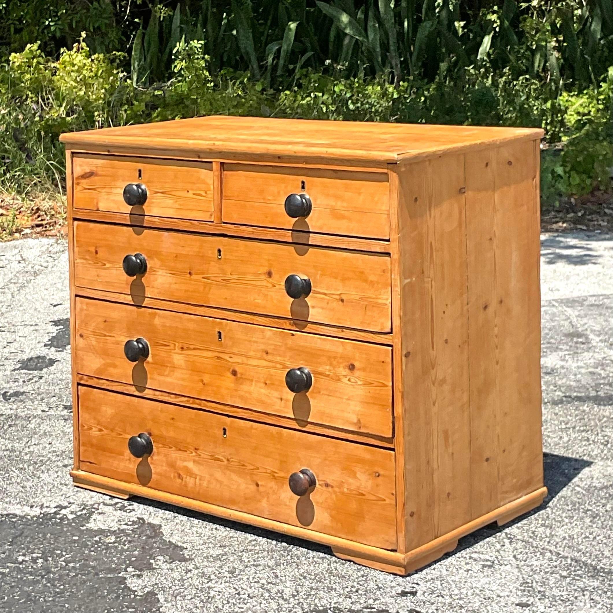 Infuse your space with Bohemian flair and historical charm with this Vintage Boho 19th Century Pine Chest of Drawers. Crafted with enduring pine and adorned with eclectic details, it captures the adventurous spirit of 19th-century America, adding
