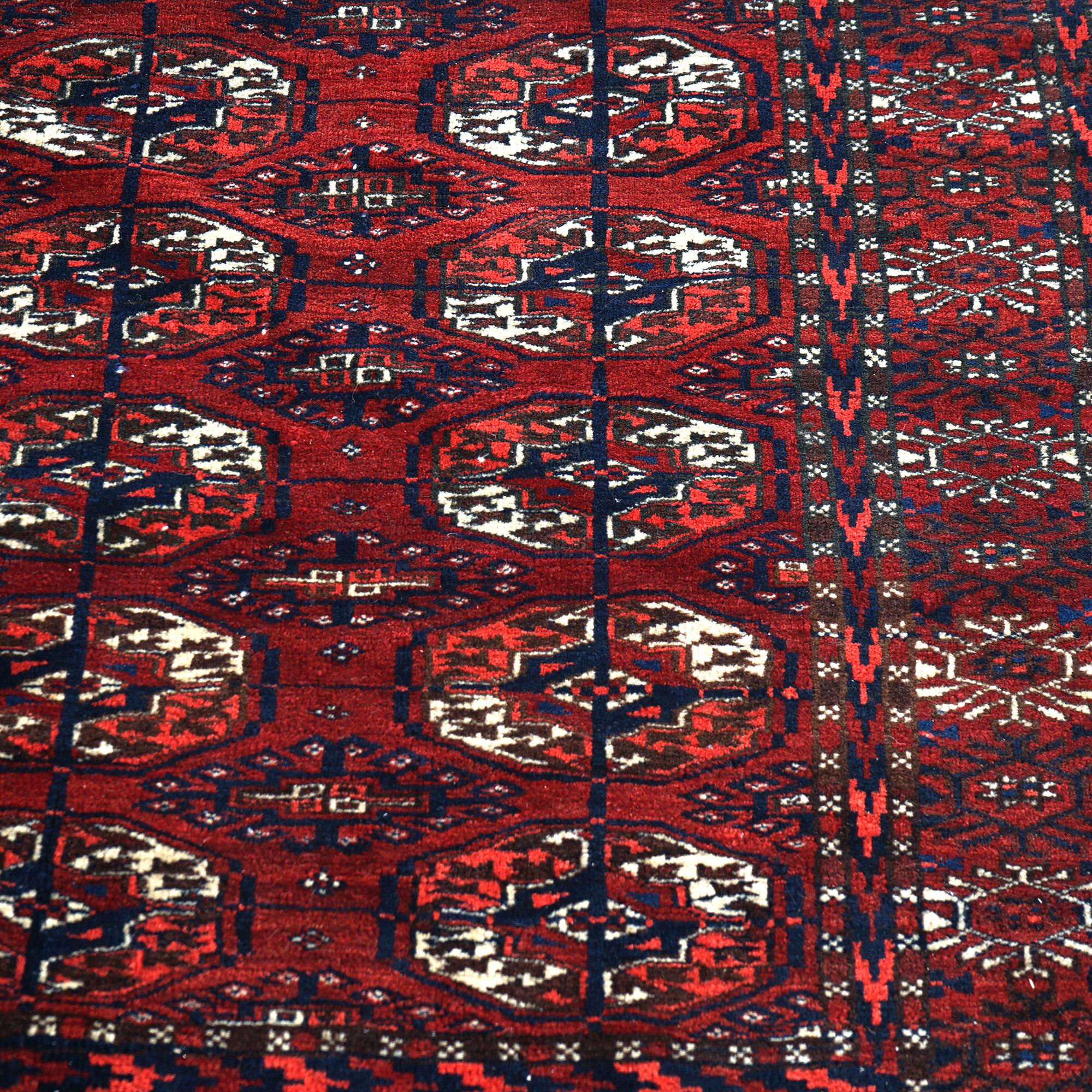 An antique Bokara Tekke Nomadic Tribal oriental rug offers wool construction with repeating geometric design, circa 1930

Measures - 77.5