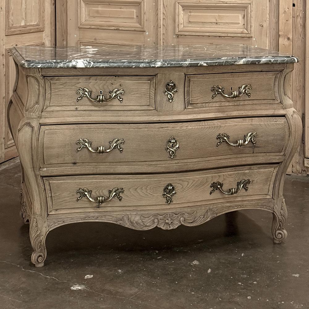 Antique Bombe Marble Top Commode in Stripped Oak is the result of an evolution that occurred over many centuries in Europe, originating in what is now Italy.  The sensuous shape of the casework reminds one of the female form, accentuated by fine
