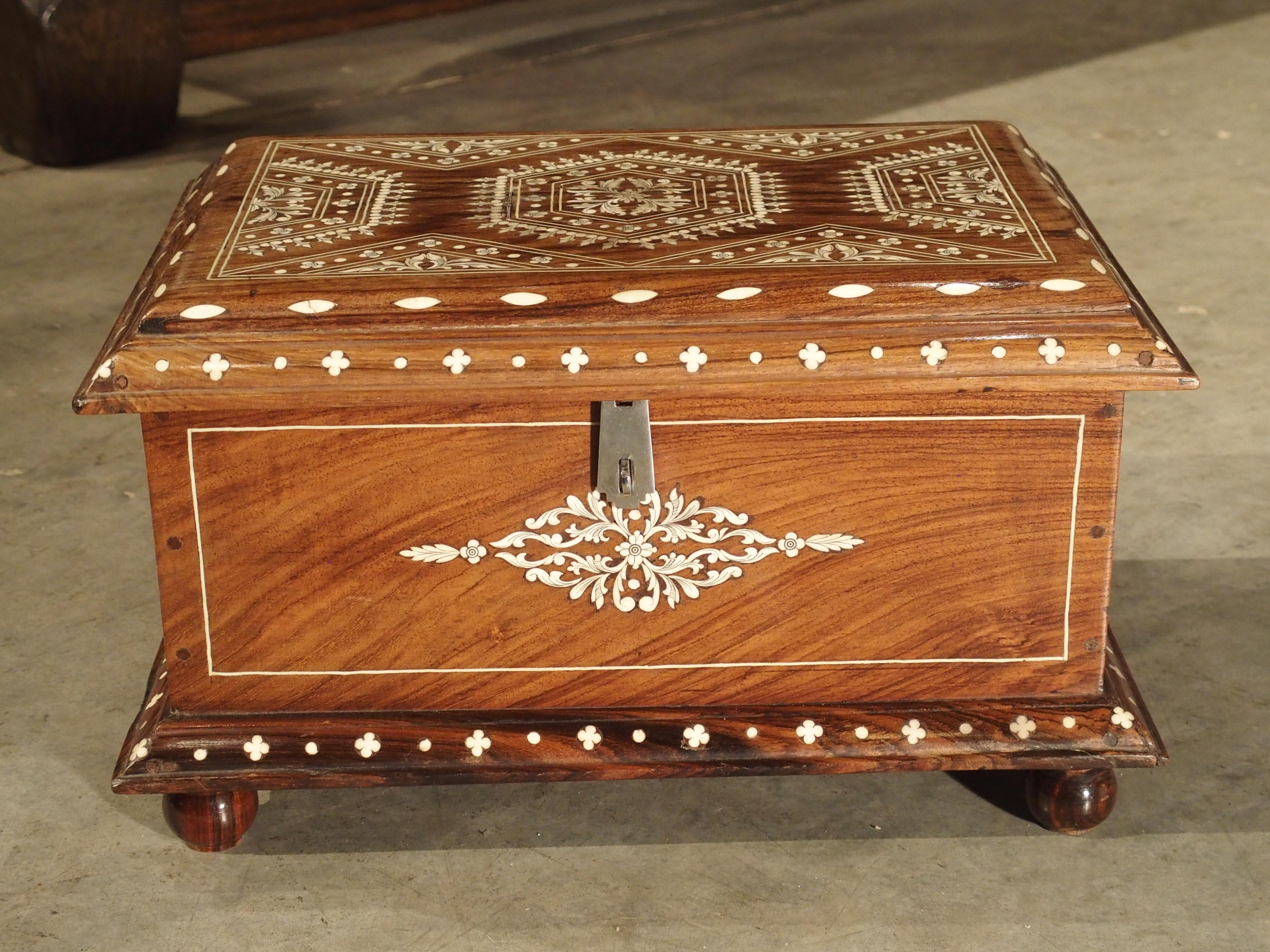 This lovely 19th century table trunk from Southern Iberia has been carved from exotic wood and intricately decorated with inlaid bone.

The Iberian Peninsula is separated from North Africa (specifically Morocco) by the Strait of Gibraltar. At its