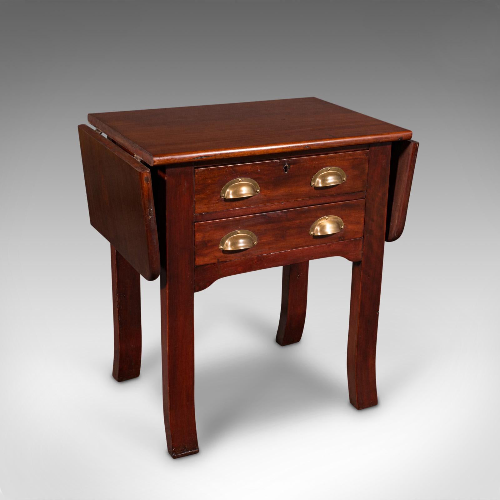 This is an antique bookbinder's press table. An English, mahogany and brass drop-flap occasional table, dating to the Victorian period, circa 1880.

Delightfully petite, with superb quality and appealing form
Displays a desirable aged patina and