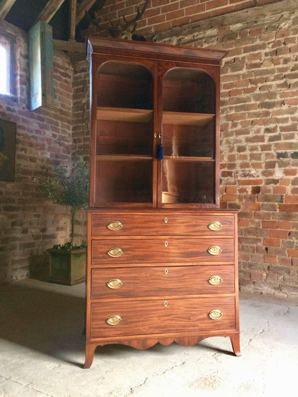 A magnificent and extremely beautiful early 19th century Mahogany bookcase over chest, circa 1845 fitted with two glass panelled doors (with original wavy glass) enclosing four adjustable shelves, with original working lock and key, over chest of