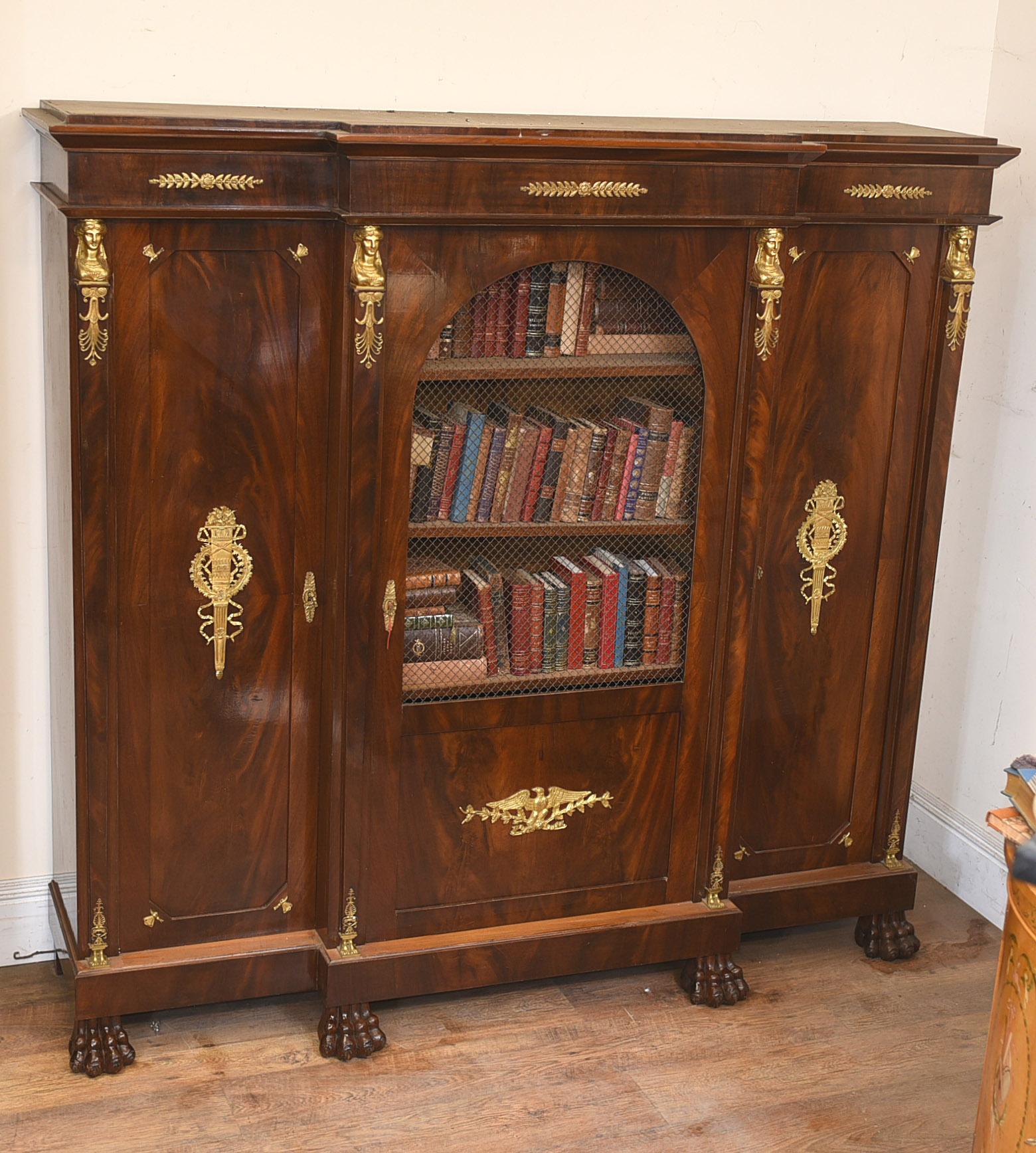 - Gorgeous French Empire antique bookcase or cabinet in flame mahogany
- Hopefully the photos do this stunning piece some justice
- It's ant antique and we date it to circa 1880
- Ormolu fixtures are orginal and in great shape, including pharo