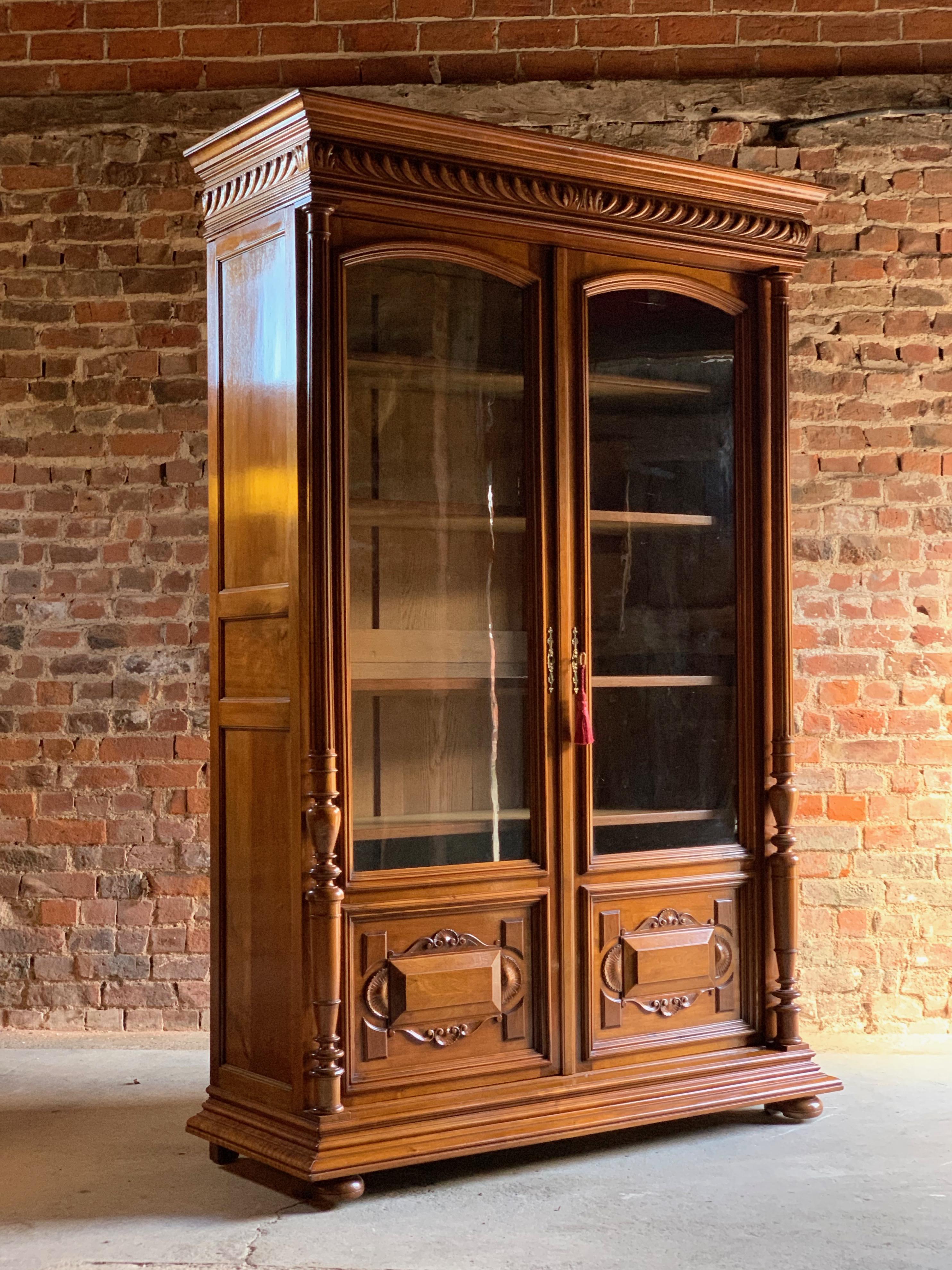 Fabulous antique 19th century French solid walnut bookcase vitrine circa 1890 Number 3

A fabulous tall and elegant 19th century French walnut two-door glazed bookcase vitrine circa 1890, the overhanging moulded carved cornice above two panelled