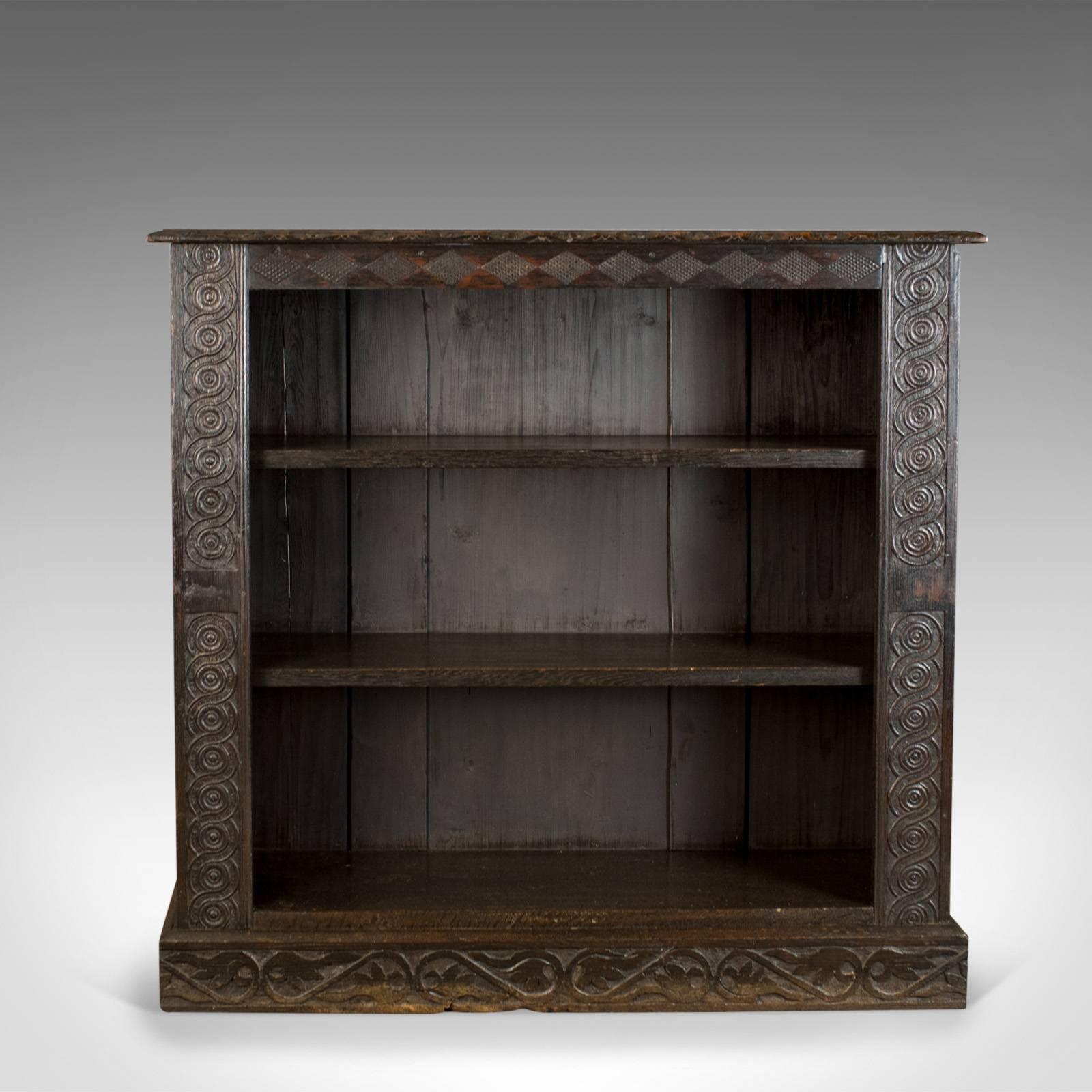 This is an antique bookshelf, an English oak, Victorian bookcase with Jacobean overtones dating to circa 1880.

Mid-sized bookshelf with a dark oak finish
Desirable aged patina and displaying Jacobean overtones
Pair of fixed shelves offering 24