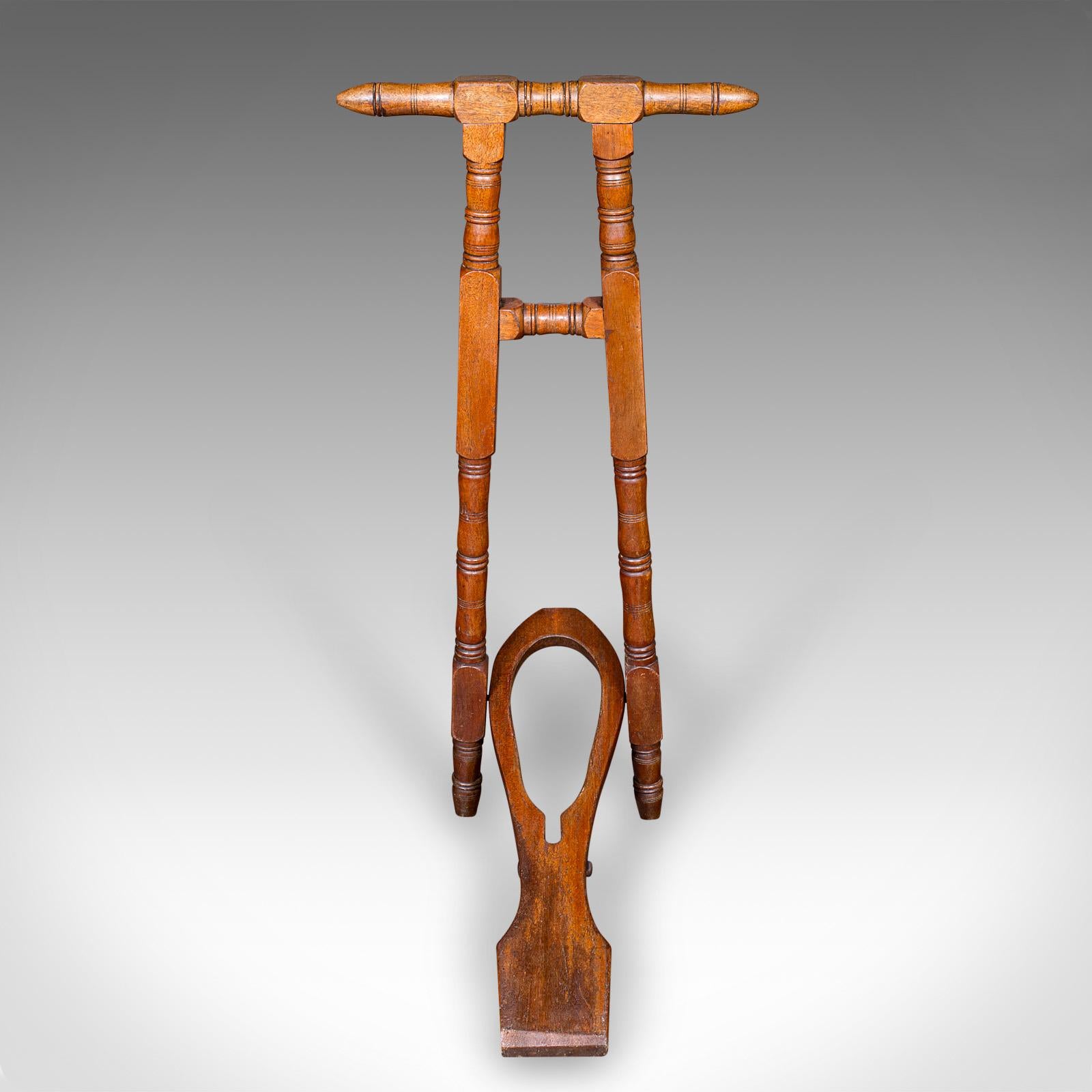 This is an antique boot jack. An English, walnut folding shoe pull, dating to the Victorian period, circa 1870. A fine example of enduring Victorian utility, with rich walnut hues and practical folding form.

Charming example of Victorian era