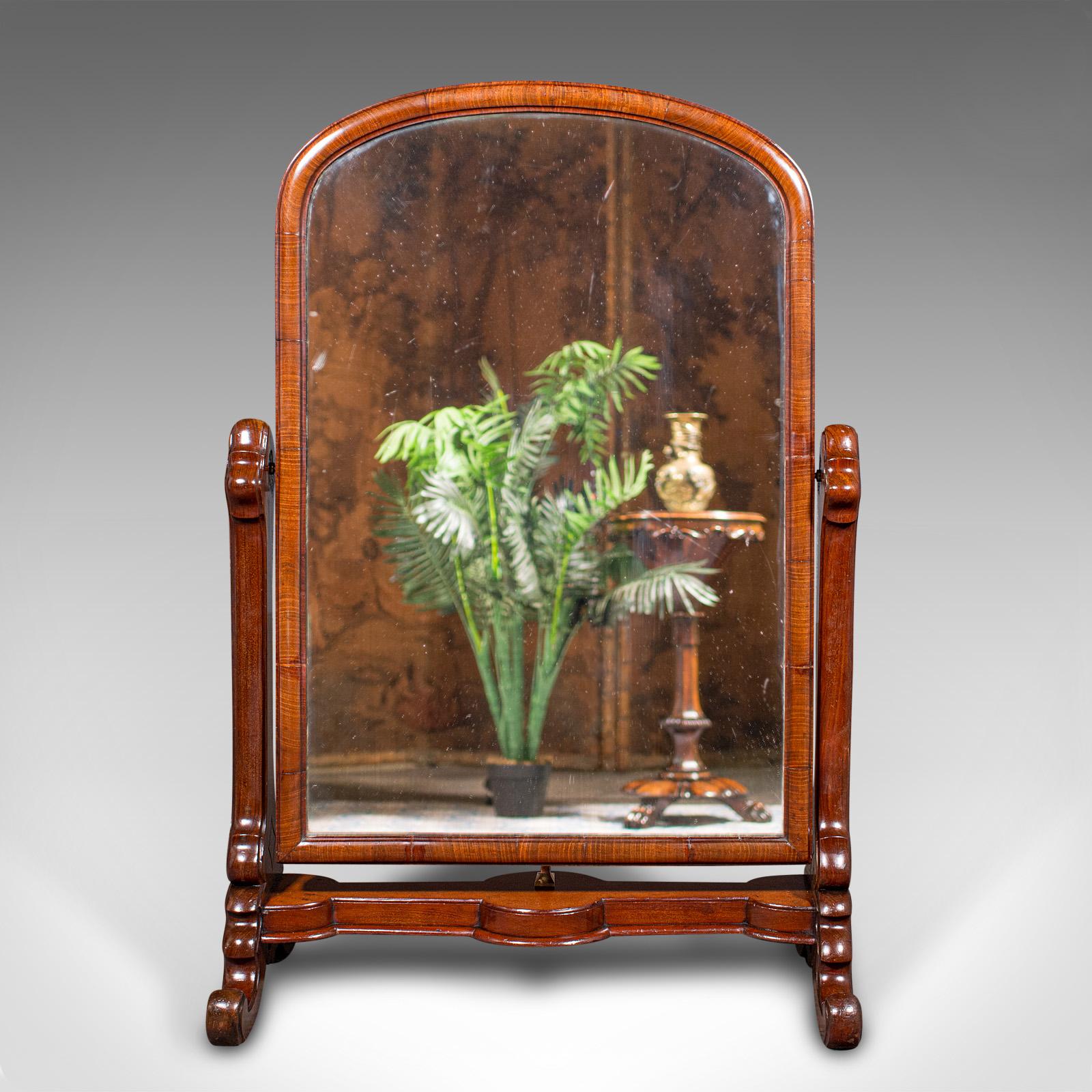 This is an antique boot maker's mirror. An English, mahogany and glass cheval mirror, dating to the early Victorian period, circa 1840.

Fascinatingly low profile, ideal for retail use or upon a large dressing table
Displays a desirable aged patina