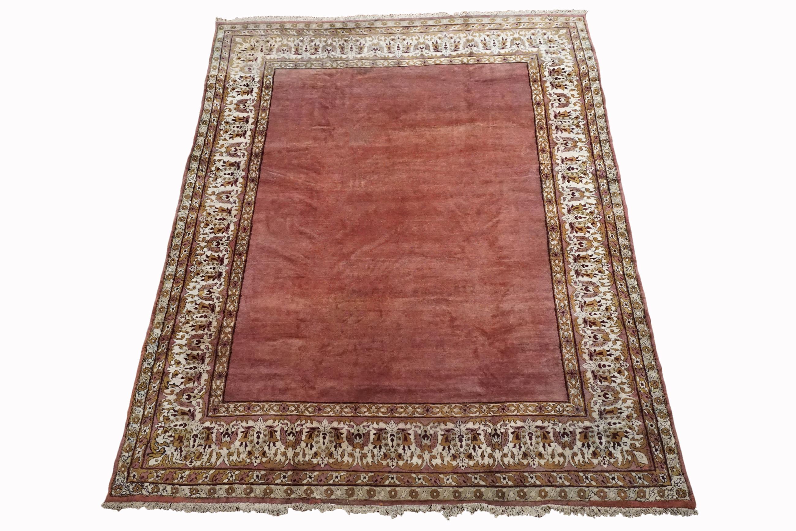 Hand-knotted wool pile on a cotton foundation.

Circa 1920

Dimensions: 8'8'' x 11'4'' 

Origin: India 

Condition: Excellent 

Field Color: Dusty-Rose 

Border Color: Ivory 

Accent Colors: Red, Gold.