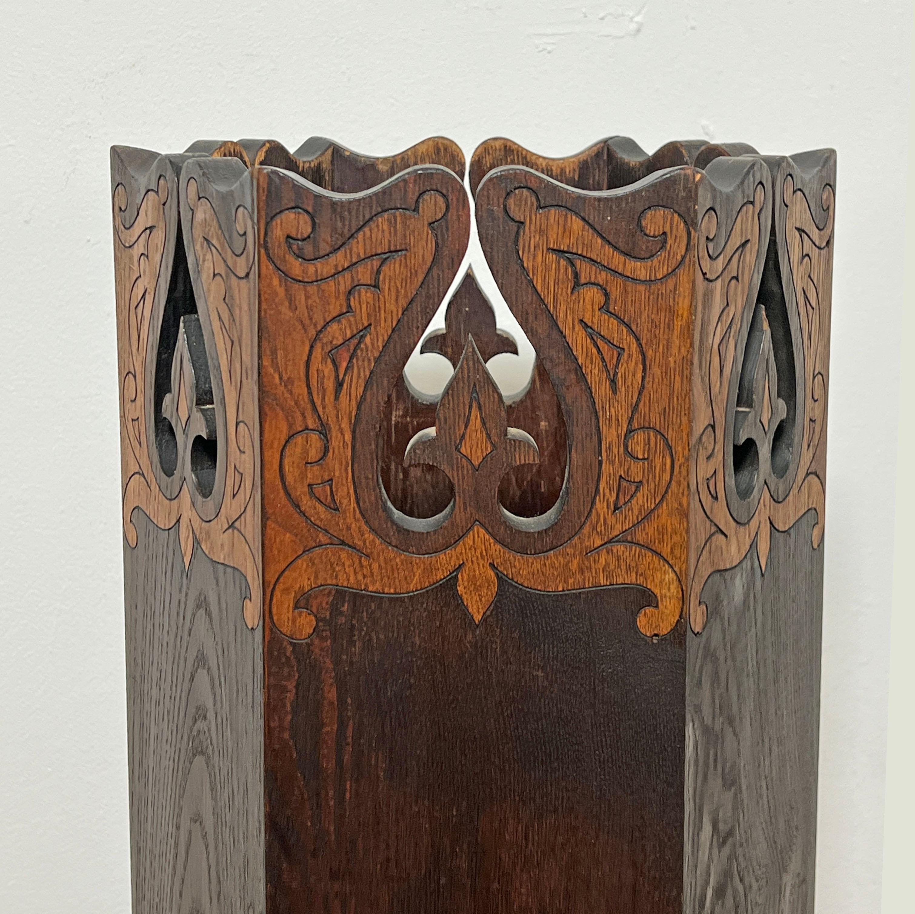 A Boston School Arts and Crafts mission oak umbrella stand with pyrographic  and cut out design, circa 1910s.