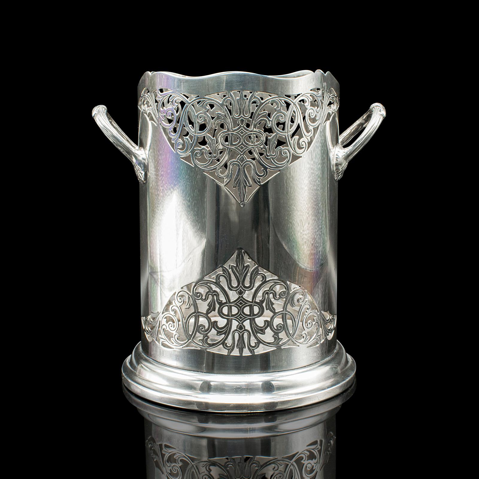 
This is an antique bottle cooler. An English, silver plated champagne magnum bucket, dating to the early 20th century, circa 1920.

Striking pierced design accentuates this charming early 20th century example
Displays a desirable aged patina and in
