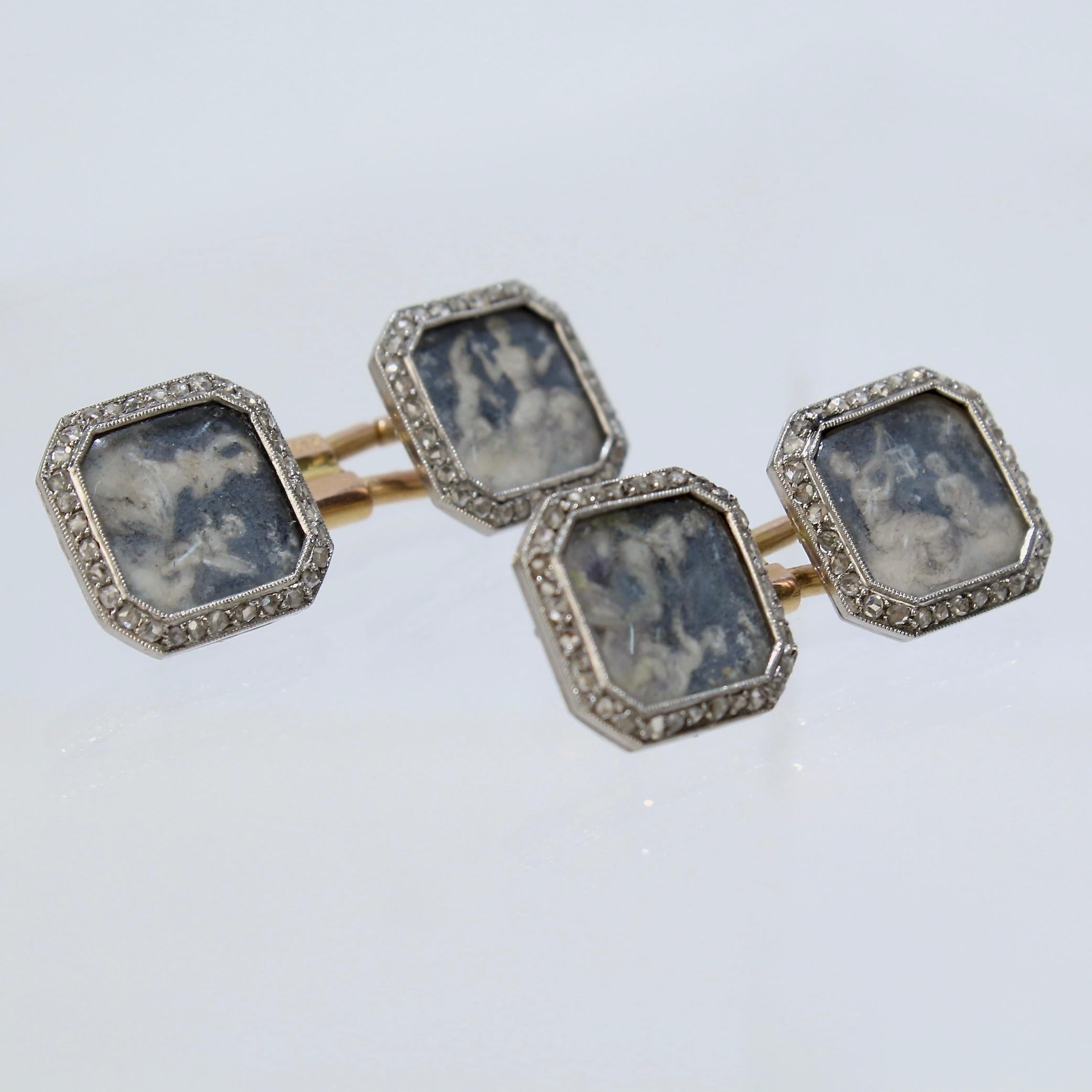 An extraordinarily rare pair of antique Boucheron cufflinks.

With diamond-set platinum frames encasing hand-painted classical scenes of a woman and a cherub under glass bezels. The scenes are possibly allegories of the Arts.

30 small diamonds