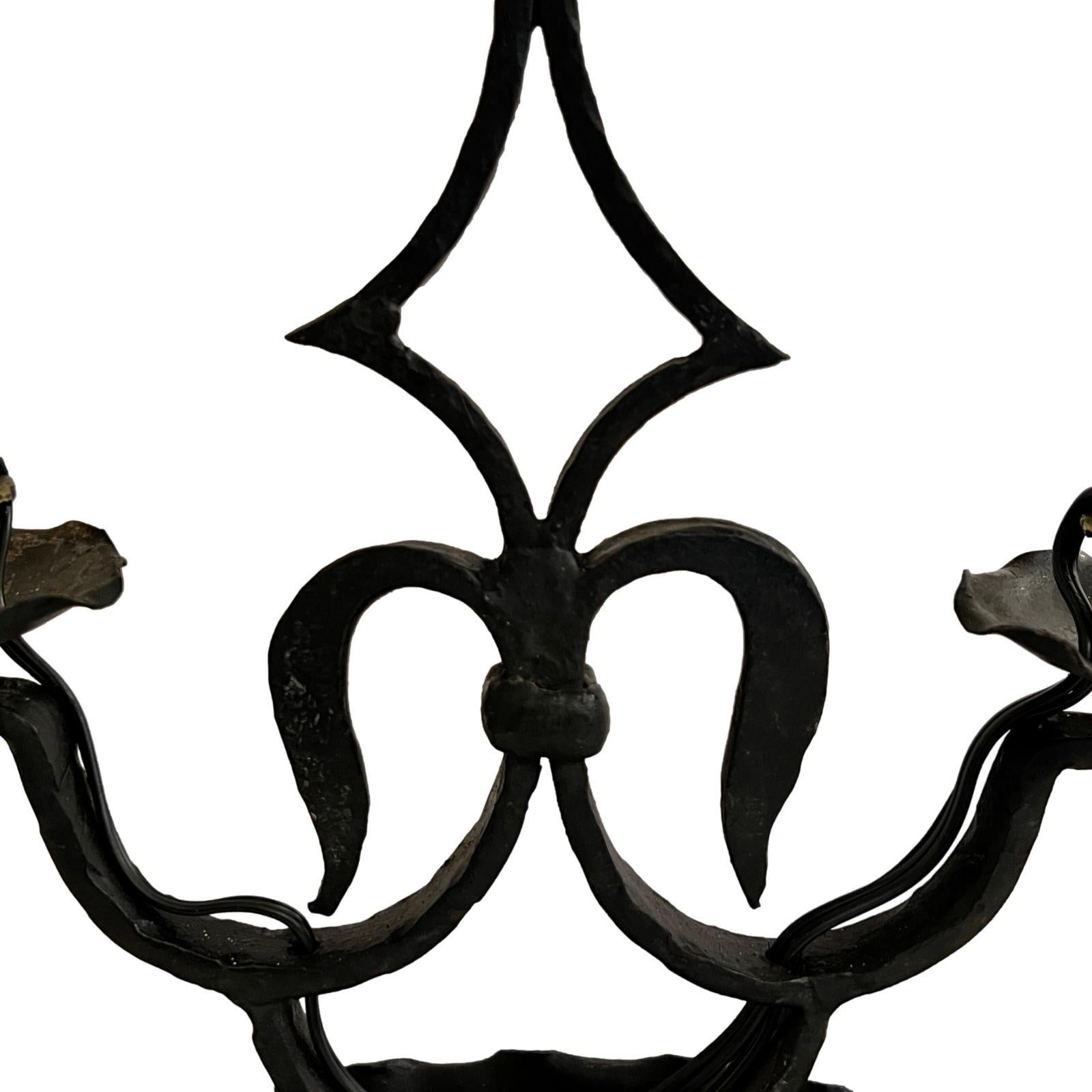 A circa 1920's French wrought iron table lamp with painted tole shade.

Measurements:
Height: 29