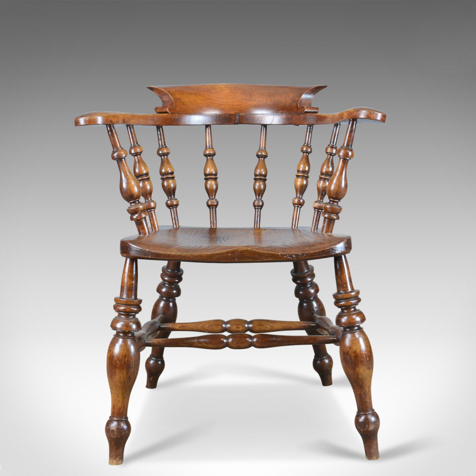 This is an antique, bow-back chair, sometimes referred to as a 'Smoker's' or 'Captain's' chair. An English, Victorian, elm, Windsor piece from the 19th century, circa 1880. 

Attractive deep, rich tones to the elm with a desirable aged