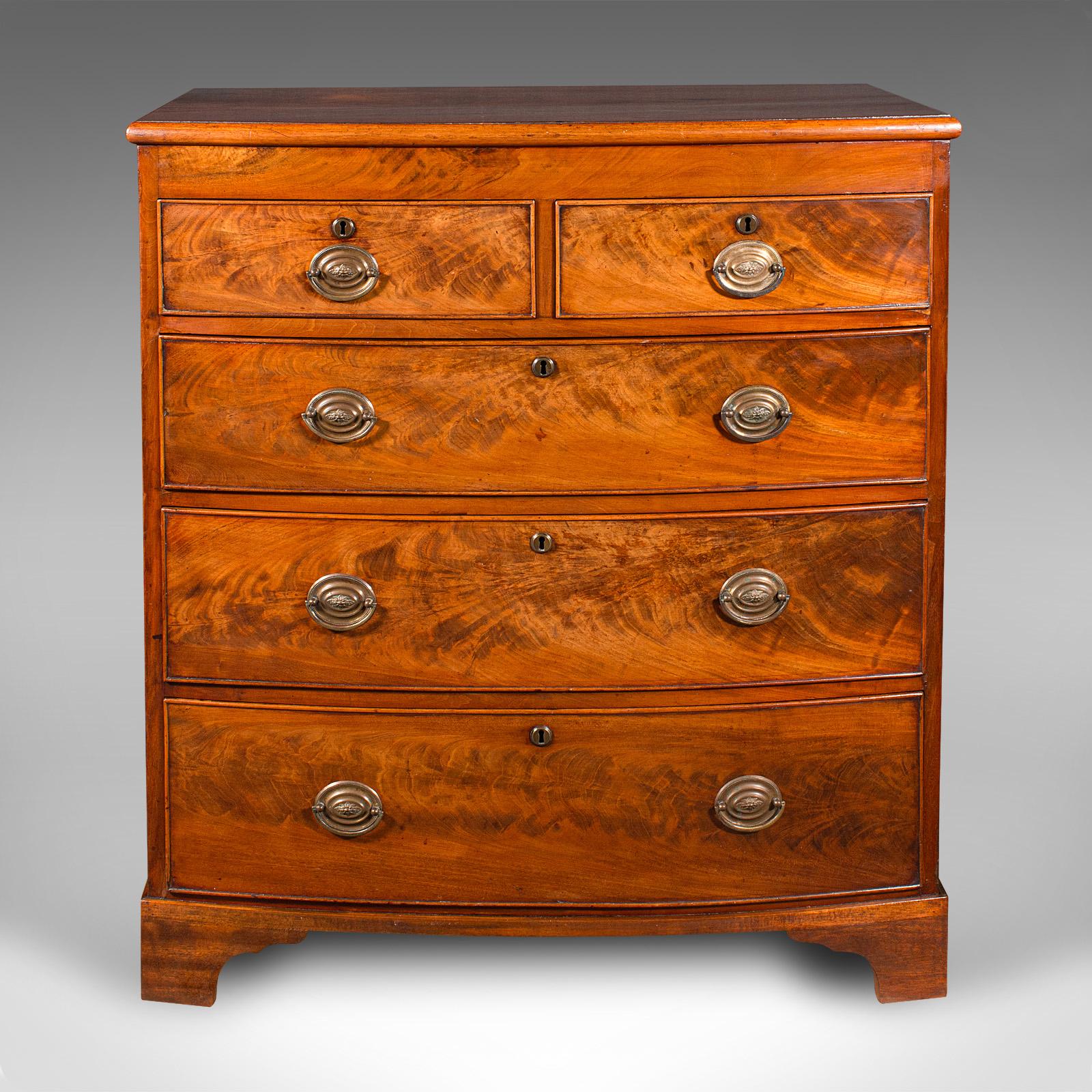 This is an antique bow front chest of drawers. An English, flame mahogany tallboy, dating to the Georgian period, circa 1800.

Graceful form and proportion to this exquisite Georgian piece
Displays a desirable aged patina and in very good