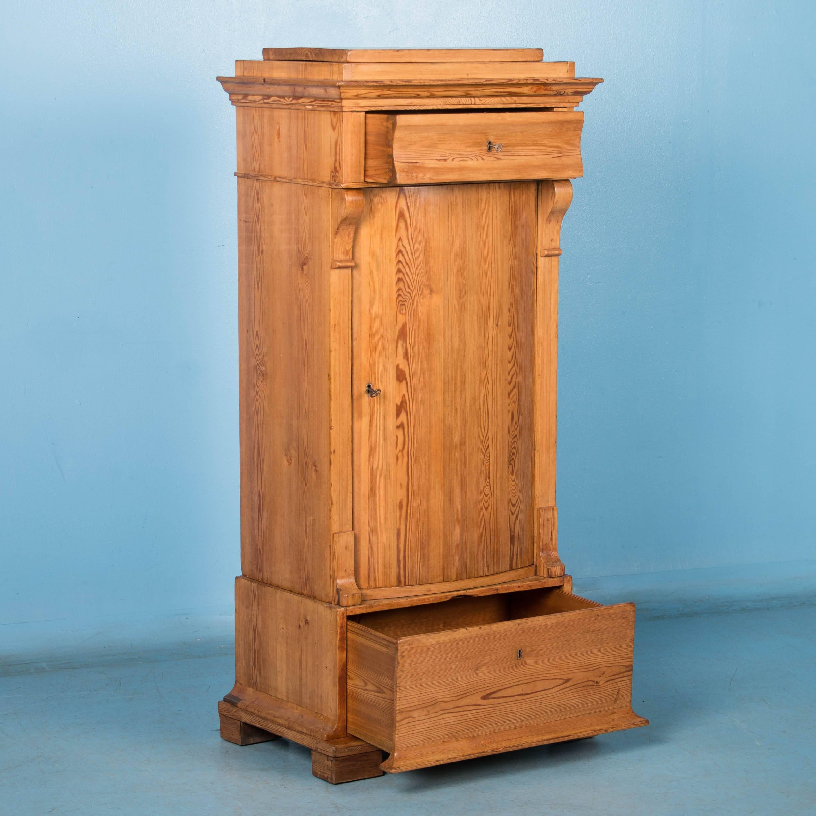 This versatile small pine cabinet, offers a number of storage options and features a couple of unique features such as the bowed cabinet door and the large drawer built into the base. Another interesting feature is the molded crown with a top plate