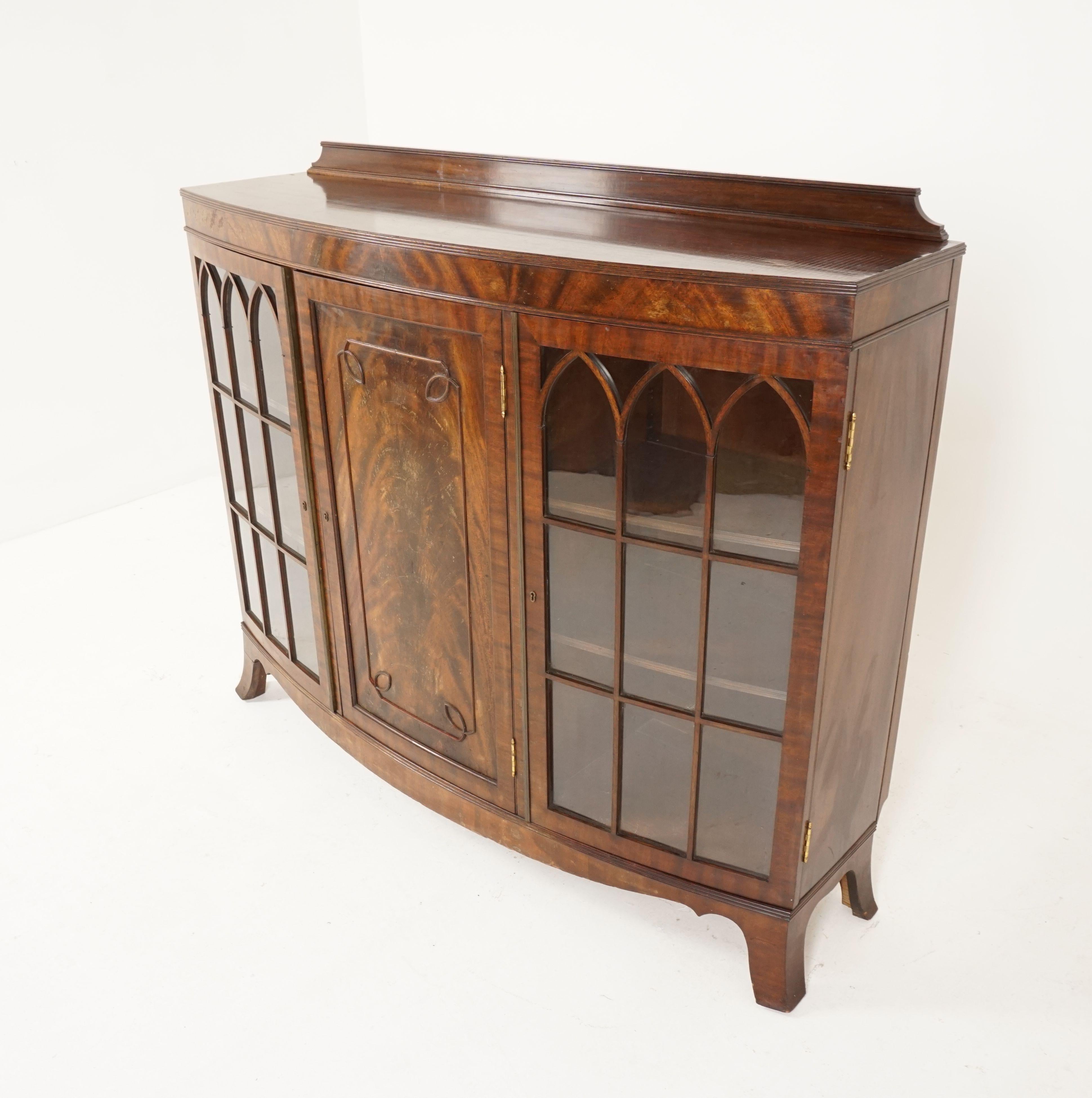Antique bow front mahogany bookcase, three door display cabinet, Scotland 1920, B2165

Scotland, 1920
Solid mahogany and veneers
Original finish
Shaped pediment on top
Rectangular top with bow front
Paneled center door with two