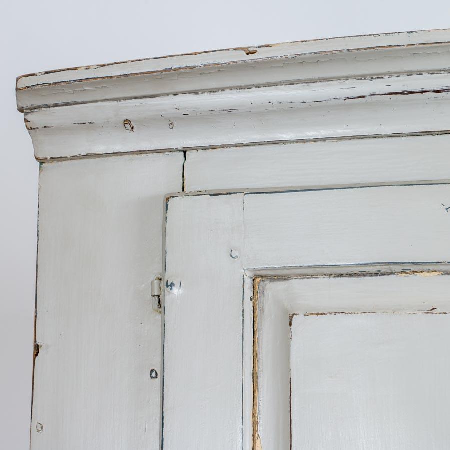 white antique corner cabinet