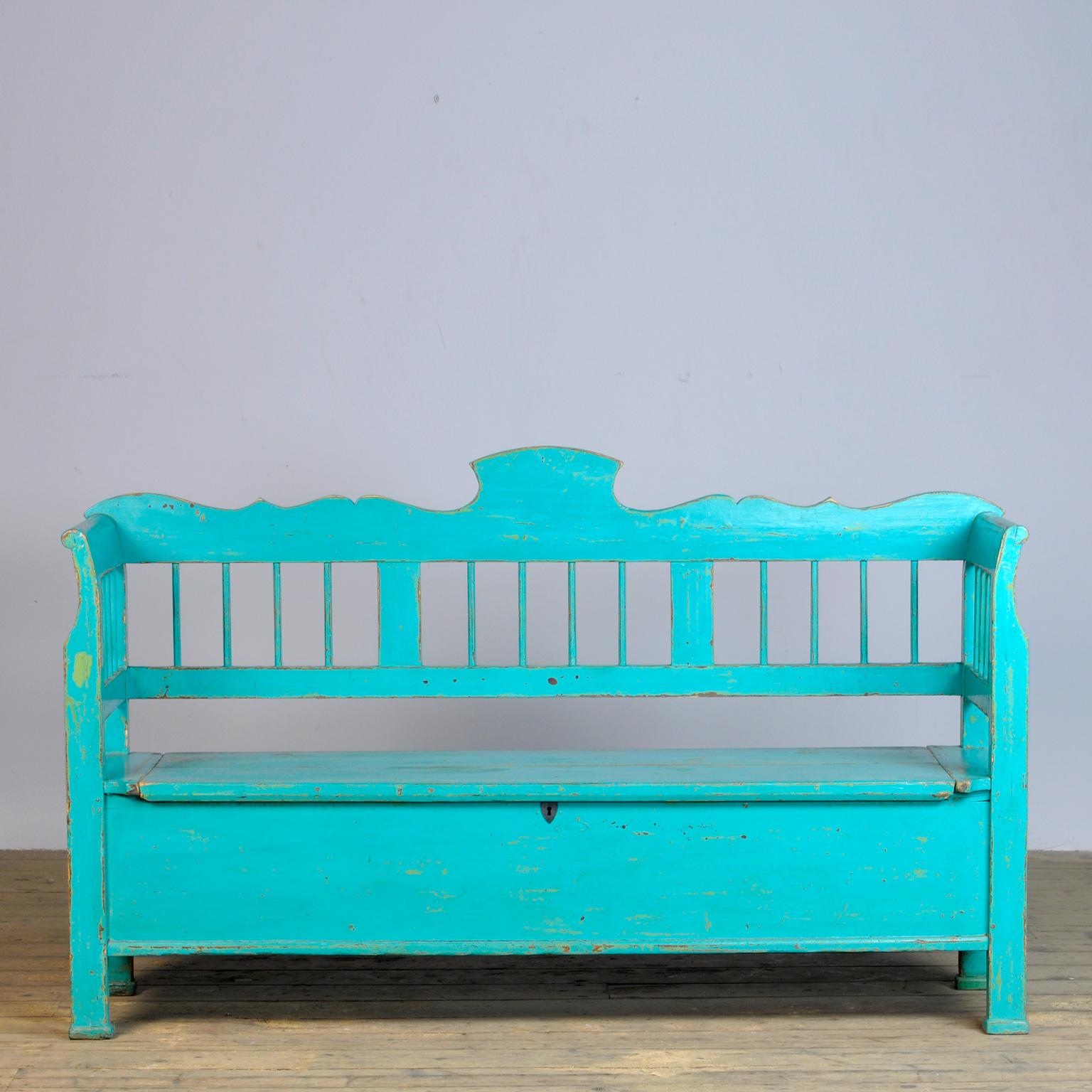 A charming bench from Hungary with the original paint. Over time and use, the blue paint has been worn away in places to the wood. With storage space under the seat. The bench is stable.