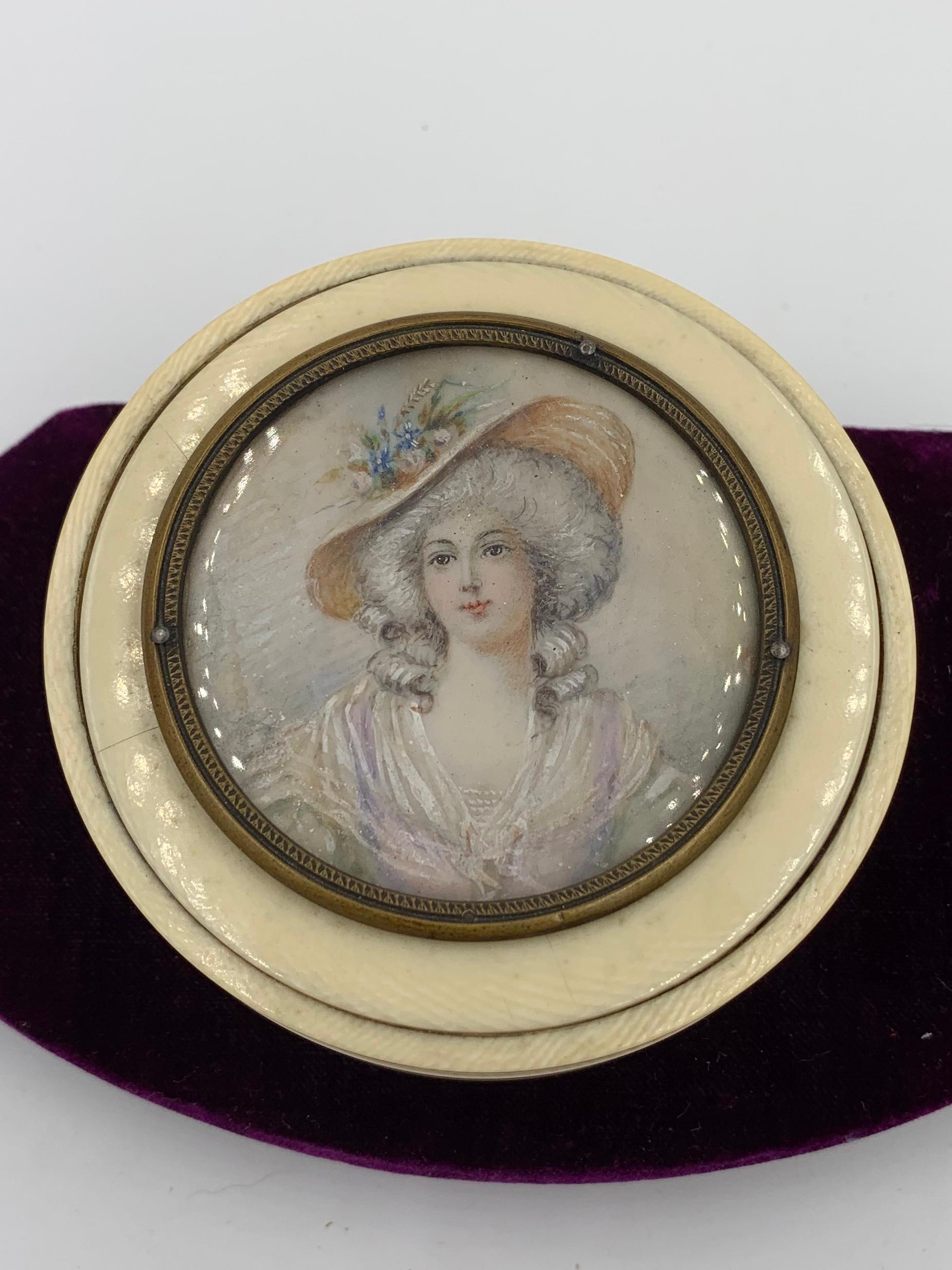 A beautiful dresser box with a hand painted portrait miniature of a woman in her hat.  The miniature is beautifully done wihth a lovely face, gorgeous hat and stunning diaphanous dress.  The quality of the painting is superb.  She has stunningly