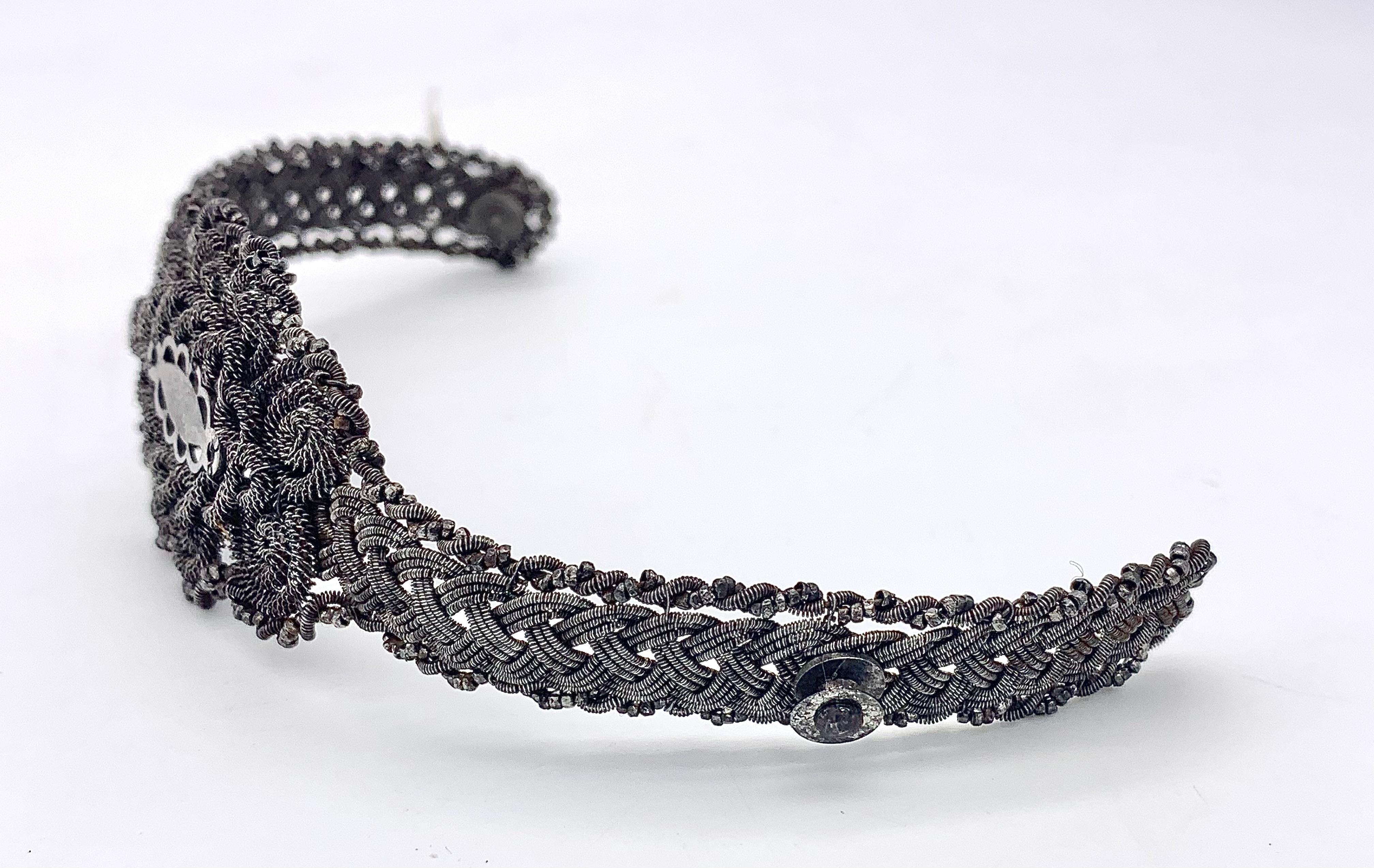 This very rare and highly collectible bracelet is a so called Silesian Wire bracelet. It was hand crafted out of on length of iron wire in 1830 ca. The iron wire is intricately woven  The principal ornament is a  length of a Celtic eternity pattern.