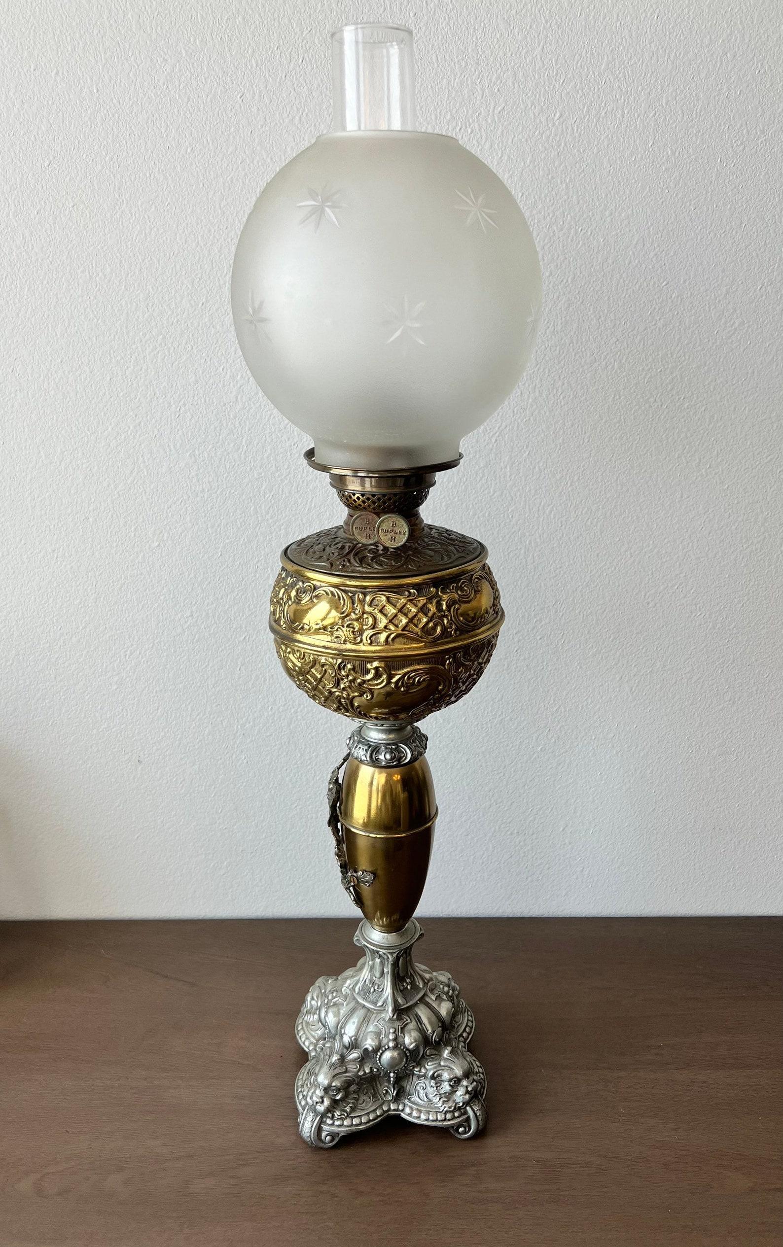 A stunning classic American Victorian era tall mixed metal oil lamp by Bradley and Hubbard. circa 1890s

Born in the United States in the late 19th century, statuesque, of fine quality, featuring frosted glass star etched sphere globe, hurricane