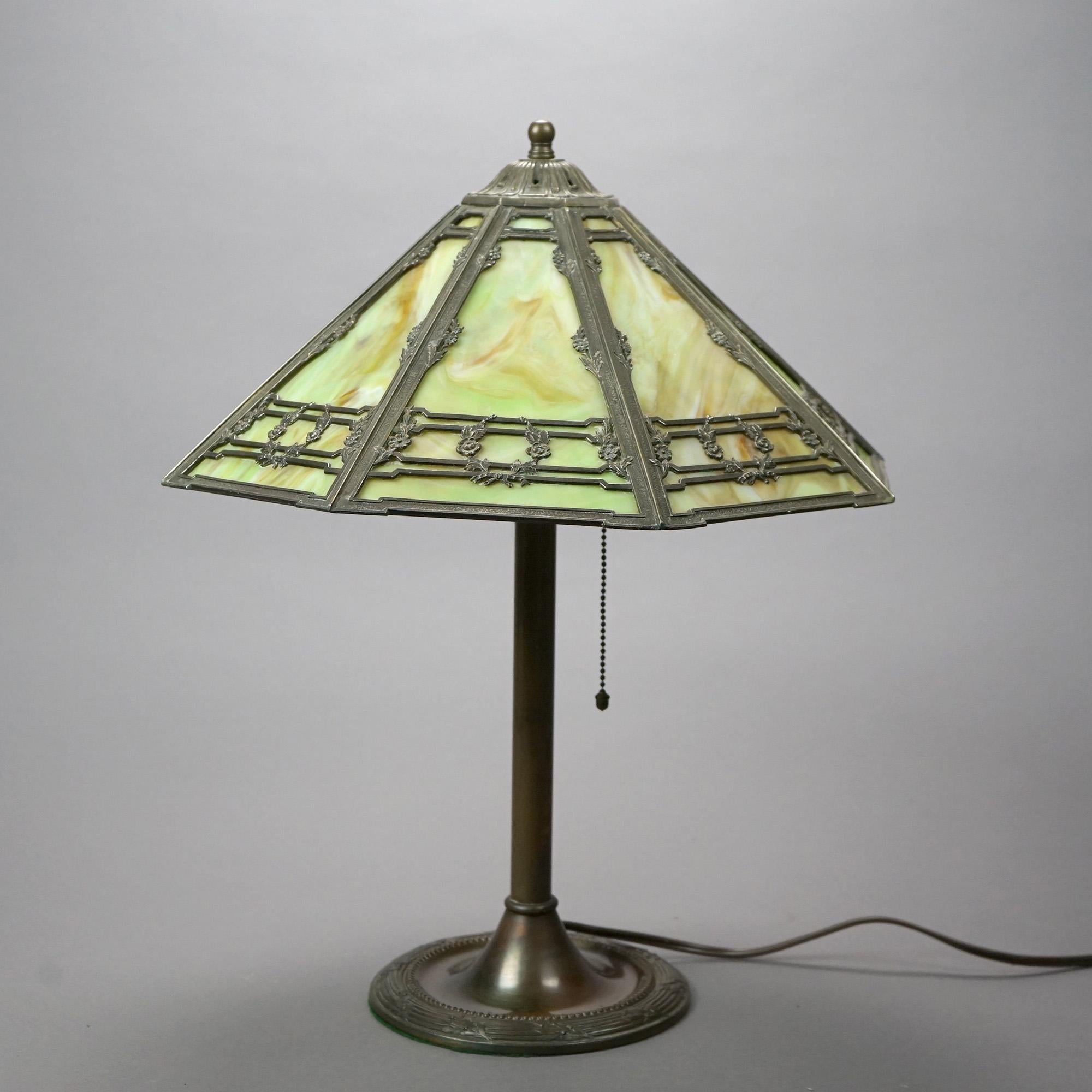 An antique Bradley & Hubbard Arts & Crafts table lamp offers slag glass paneled shade over double socket base, circa 1920

Measures- 21''H x 16.25''W x 16.25''D.