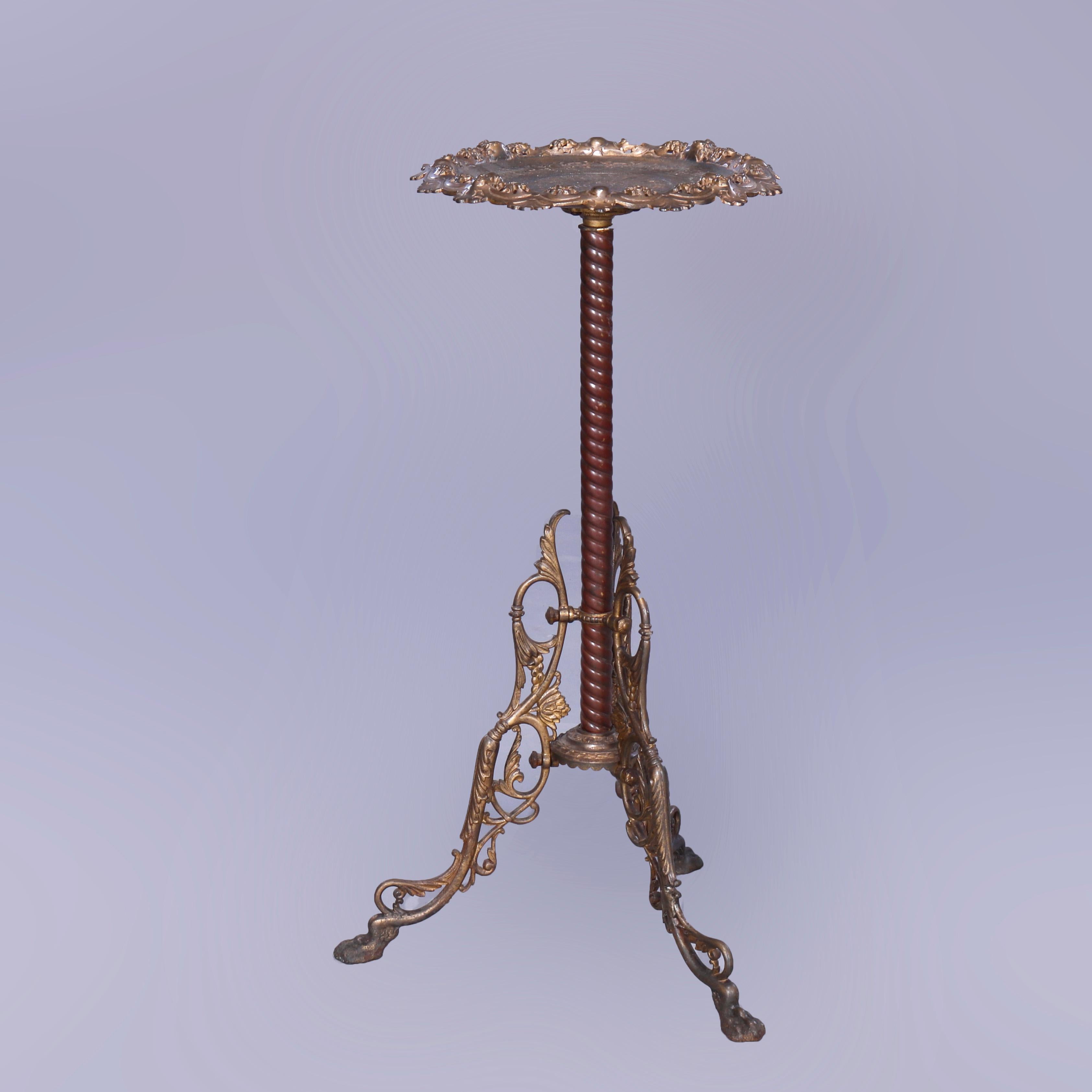 An antique Bradley and Hubbard card tray table offers bronzed metal and brass construction with tray having incised foliate design and pierced foliate rim, raised on rope twist column having three foliate cast legs, maker mark beneath tray as