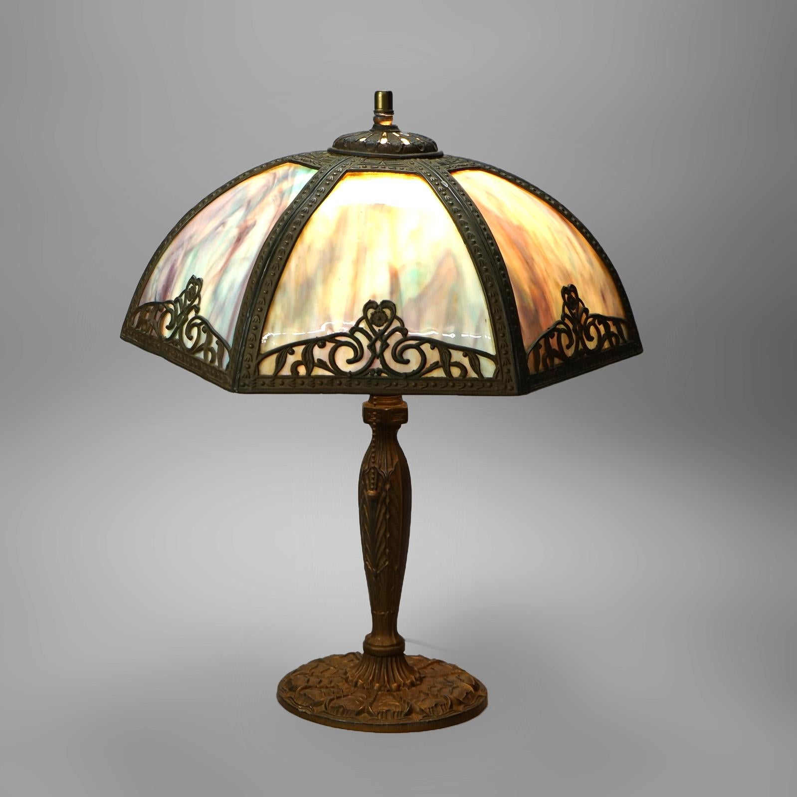 Antique Arts & Crafts Bent Slag Glass Panel Lamp in the Manner of Bradley & Hubbard with Stylized Foliate Elements C1920

Measures- 19.5''H x 16.25''W x 16.25''D