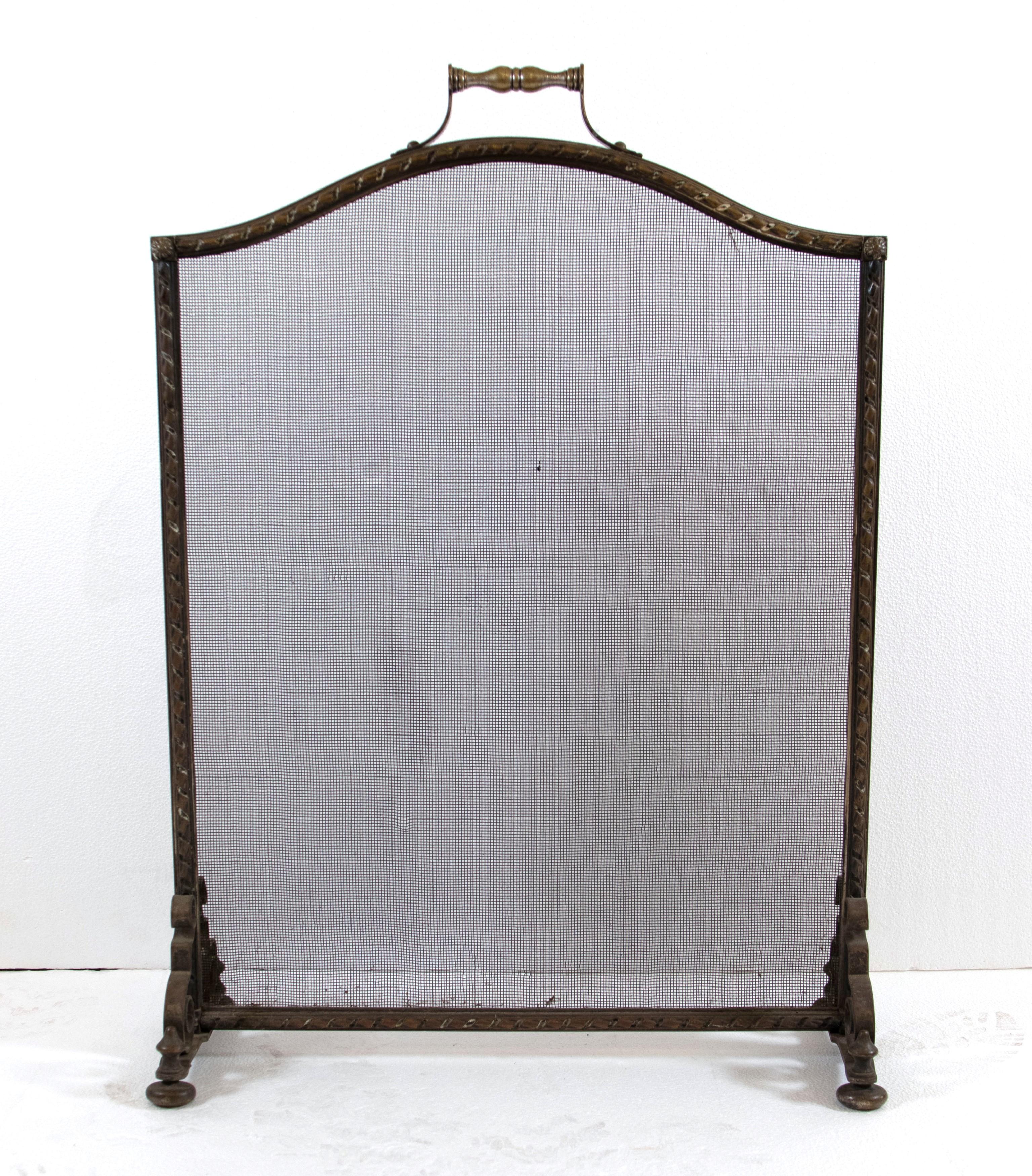 Antique bronze fireplace screen with a braid floral motif with curled steeple legs. Good condition with appropriate wear from age. One available. Please note, this item is located in one of our NYC locations.