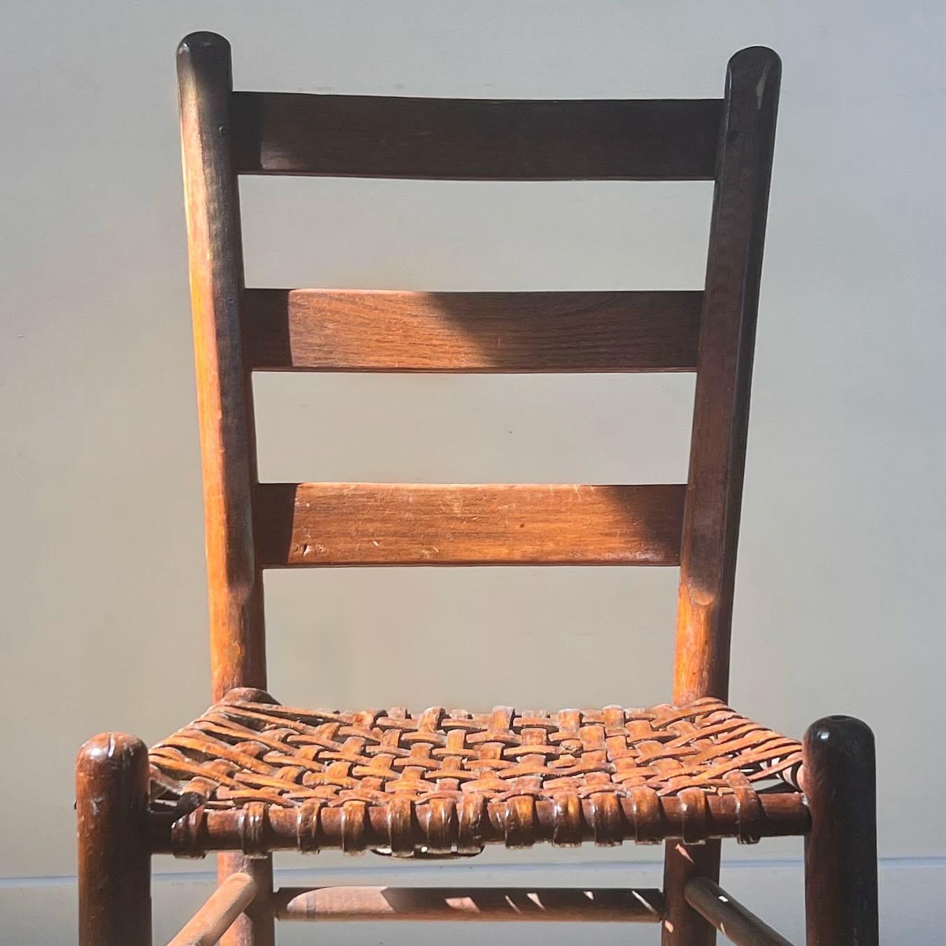 An antique wooden chair with braided seat, early 20th century. A wonderful little example of the early American craftsman movement. Signs of wear include scuffing but overall this chair is in fabulous condition for its age. Pick up in central west