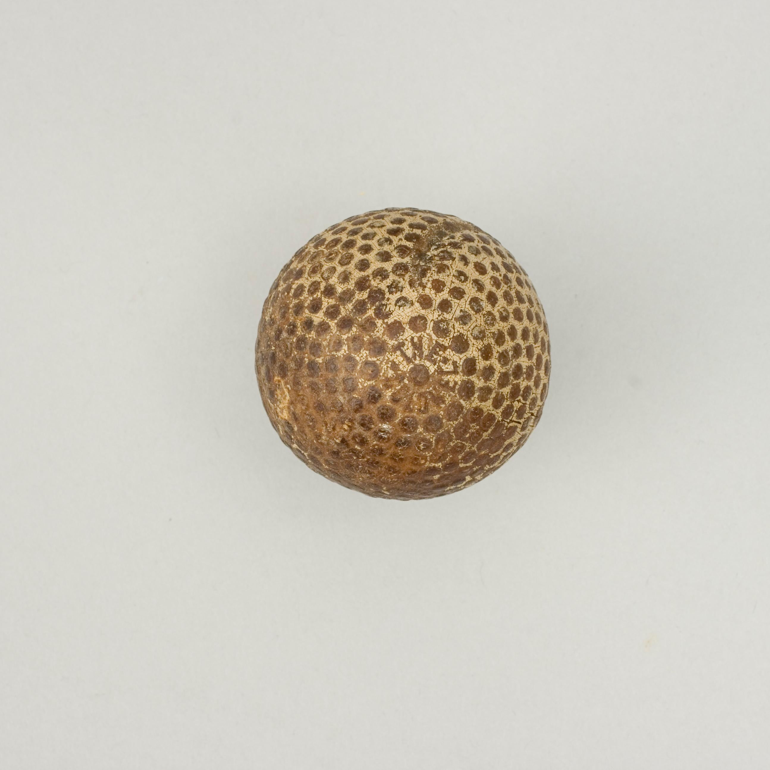 Bramble Pattern Golf Ball By St. Mungo.
A good example of 'The Colonel' bramble patterned rubber core golf ball with gutta percha cover. The golf ball is in good condition and is manufactured by St. Mungo Manufacturing Co. of America, Newark, New