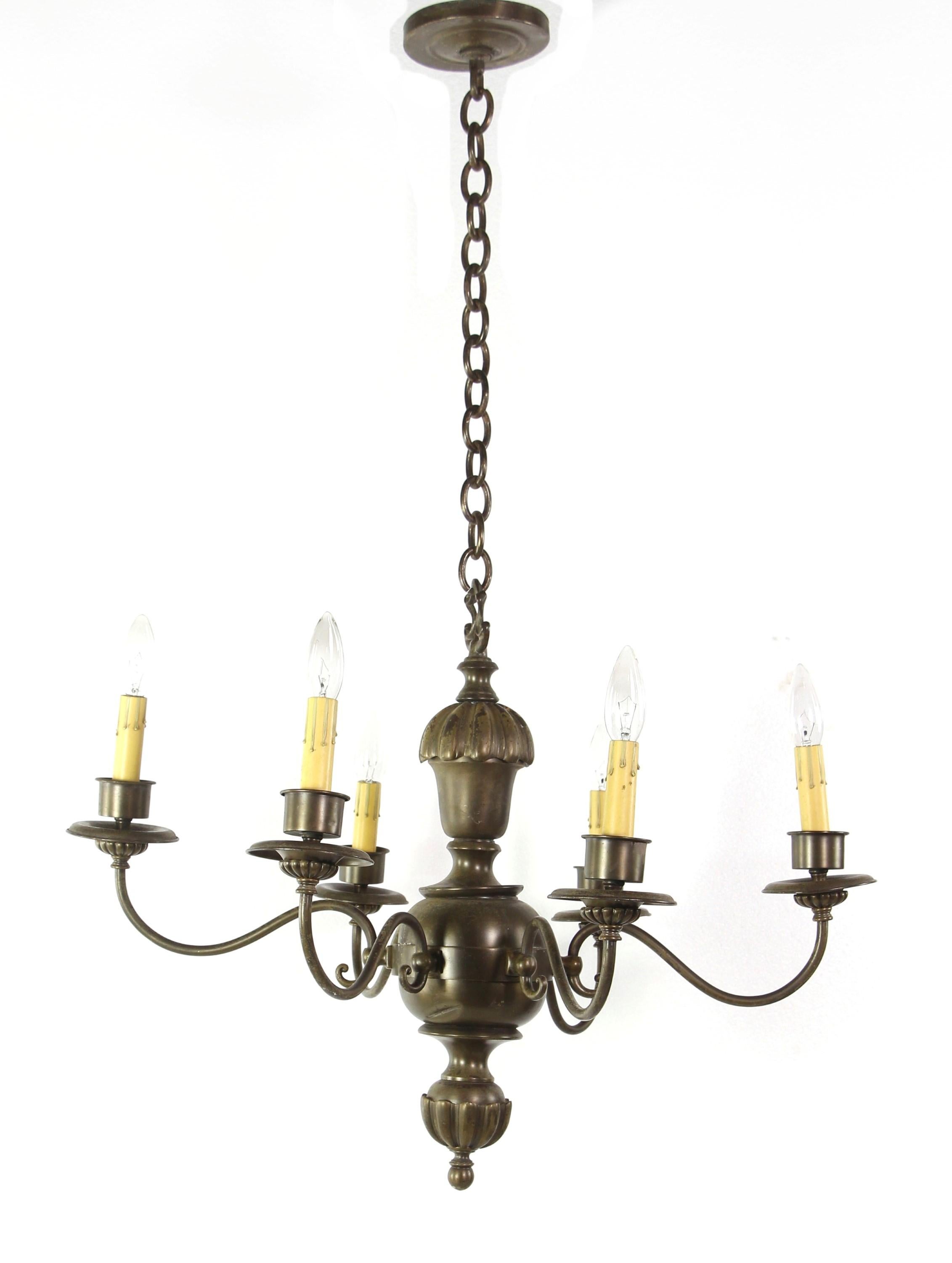 Six candlestick arm Georgian style chandelier with a dark brass patina. The chandelier is graced with fluted cast brass detail. Cleaned and restored. Takes six candelabra size light bulbs. Please note, this item is located in our Scranton, PA