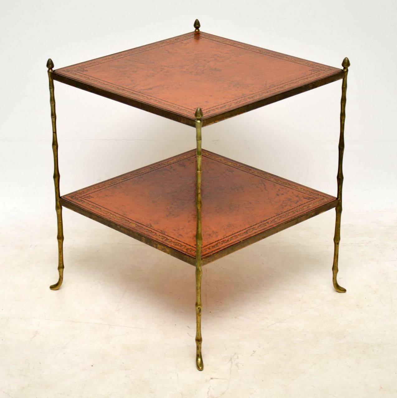 Antique brass faux bamboo two tier side table with tooled leather inserts. The brass work is naturally aged and distressed, which give this table plenty of character. It’s an unusual design and I would date this to circa 1940-1950s period. I have a