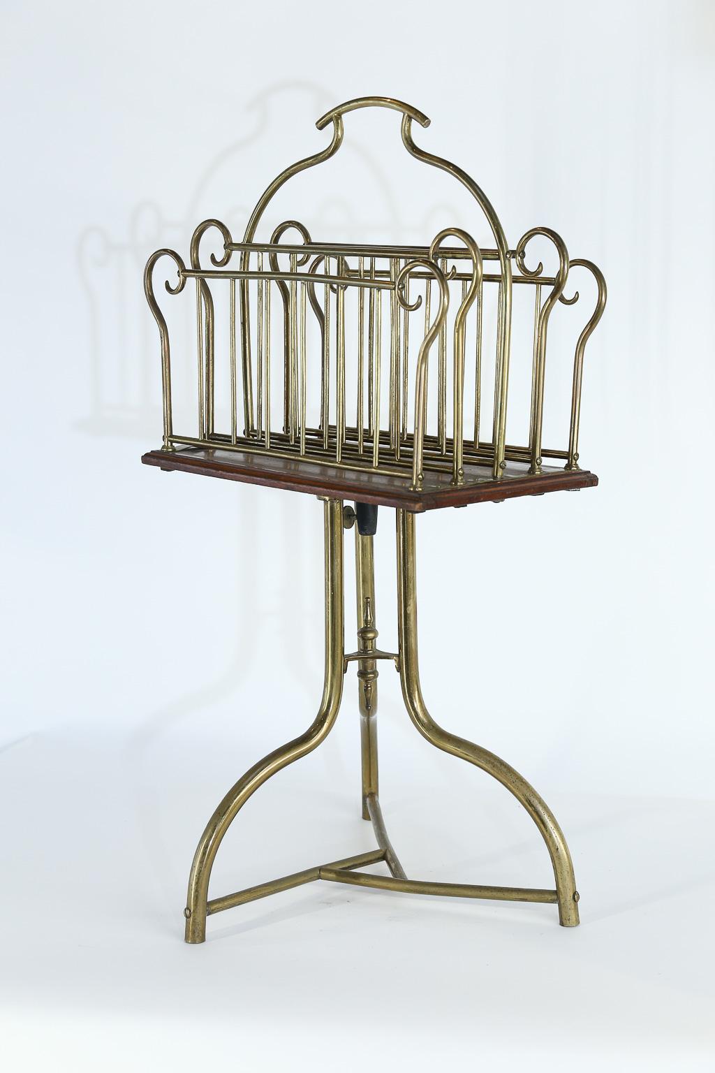 Found in France and made of brass and wood, this magazine holder is both functional and beautiful. Standing on a tripod base, the top portion turns 360 degrees for easy magazine access. This piece will add a touch of midcentury charm to any room.