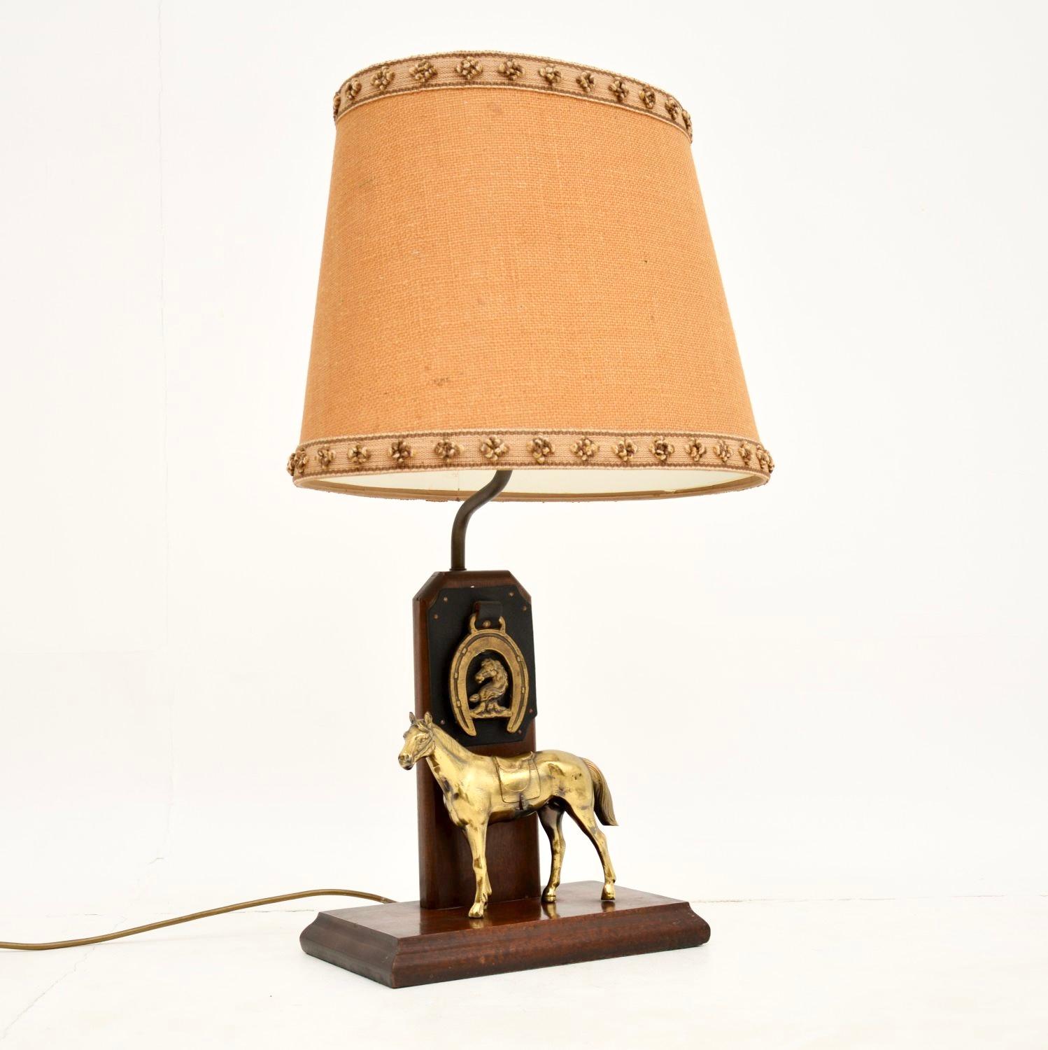 A beautifully made antique brass and oak equestrian table lamp. This was made in England, it dates from around the 1920-30’s.

It is quite large and is of excellent quality. The oak upright also has a lovely leather and brass horseshoe mount. This