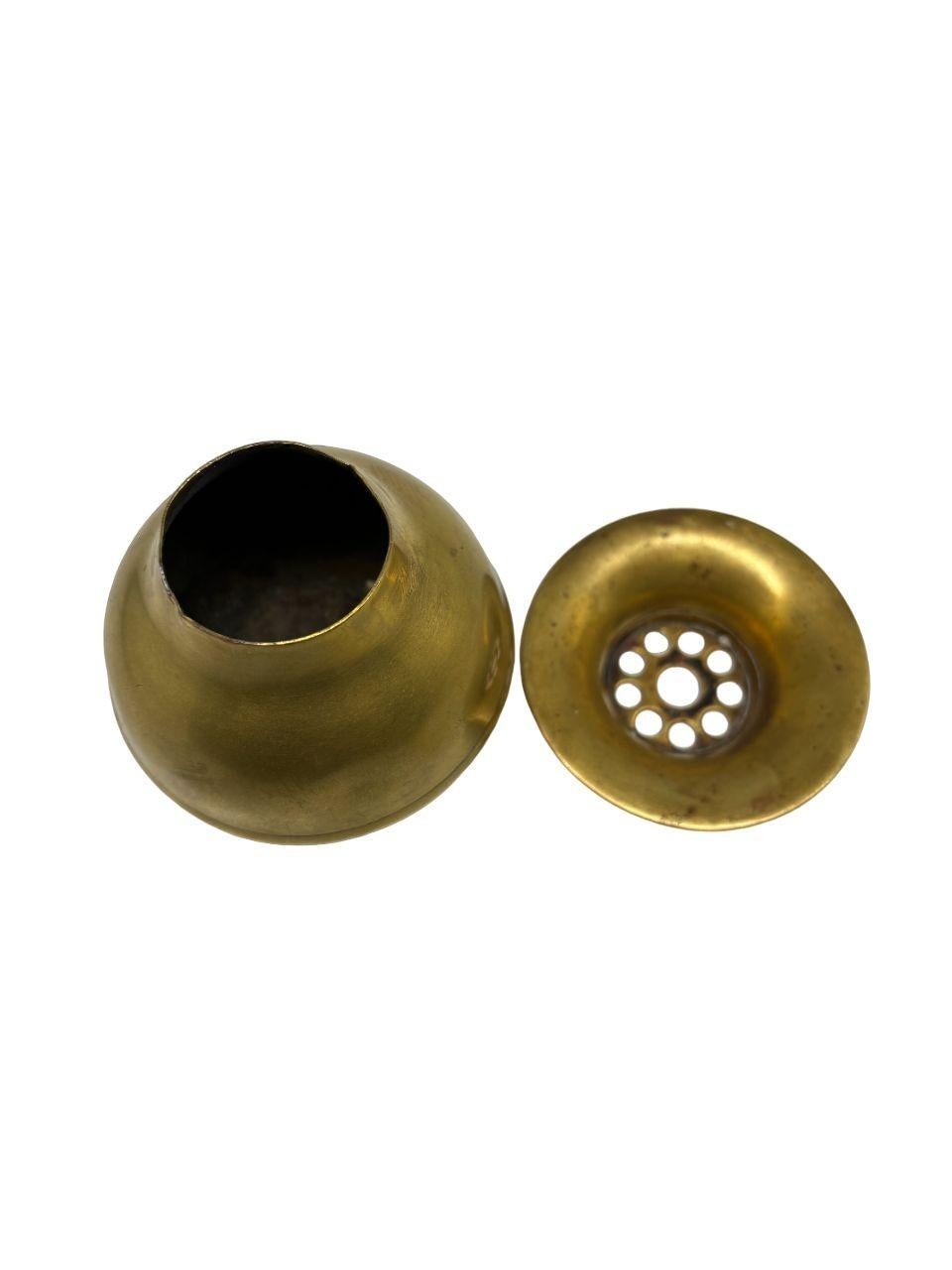 Explore the charm of this vintage brass urn ashtray with a removable top, crafted by M.A.B. Co. This classic piece exudes timeless elegance, offering a touch of nostalgia and sophistication. The removable lid adds practicality to its design, making