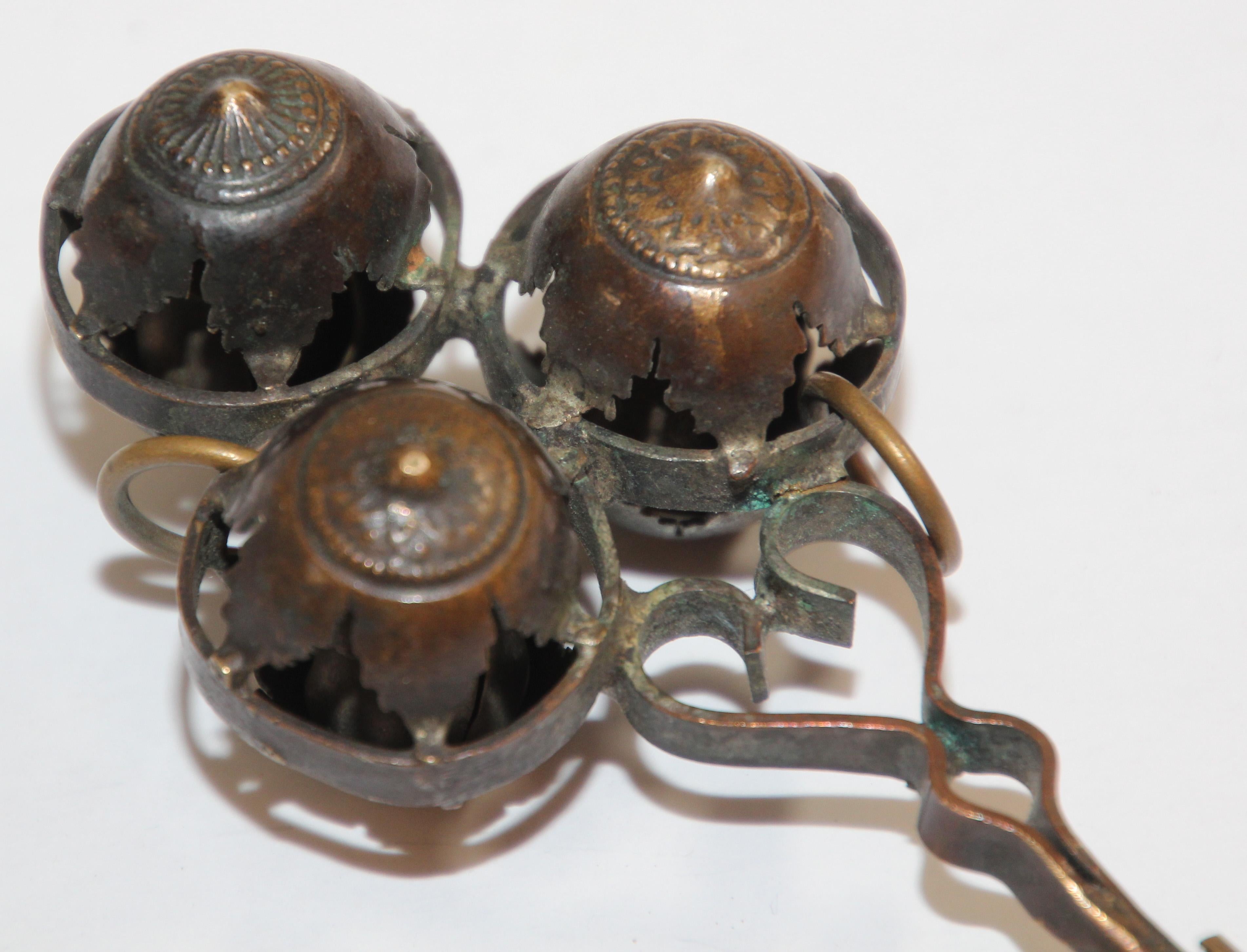 Antique brass baby rattle whistle bell dangles, India.
Handcrafted baby rattle in openwork designs with whistle handle and three decorative bell dangles.
Rare Hindu collector piece.
Dimensions: 4.5