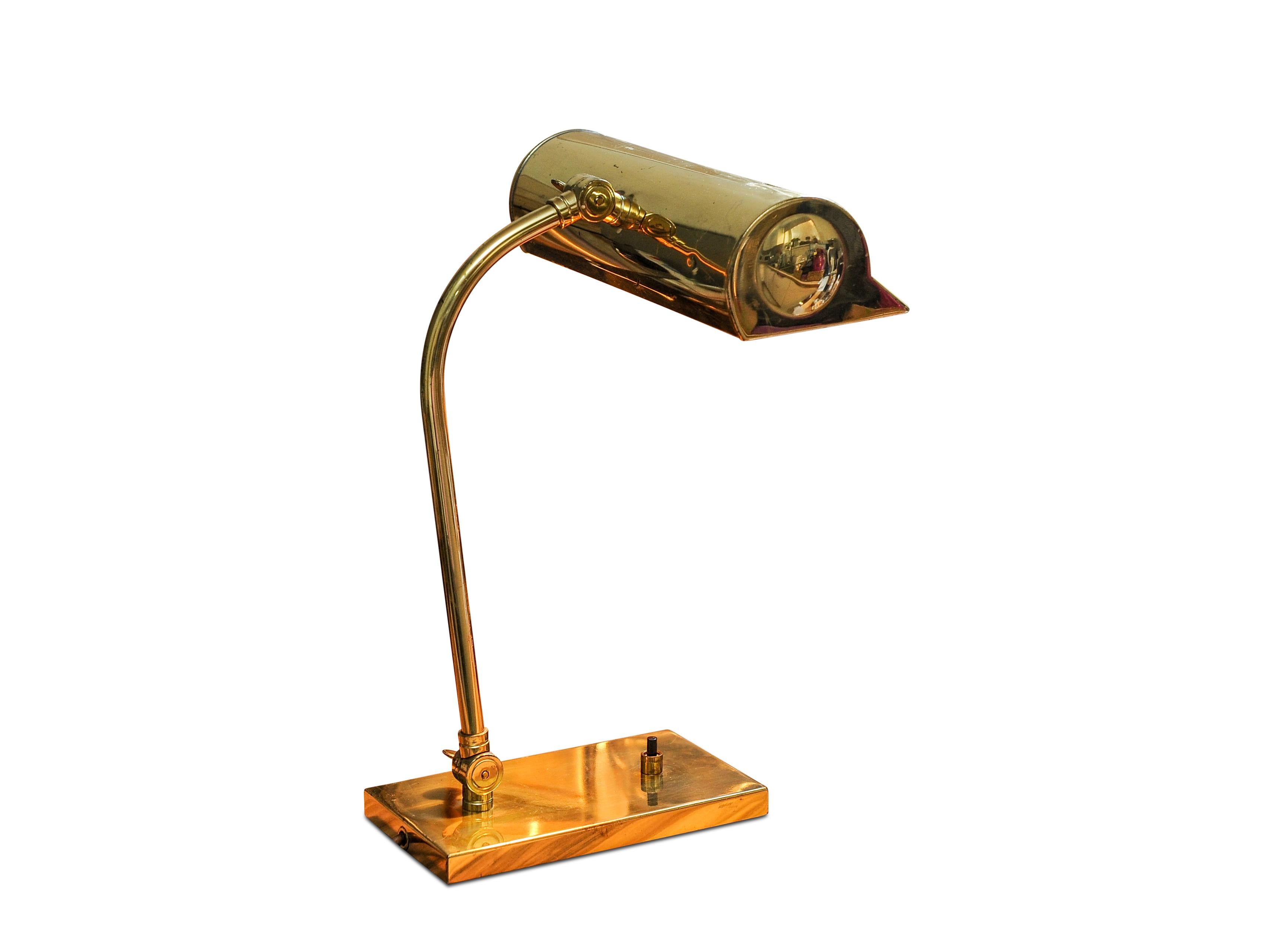 1940s Classic British brass bankers desk lamp with brass pivotable shade with an ebonized push button switch.

Full height: 36cm I Width of shade 23cm
Base: Depth 18.5 cm & width 10.5cm.